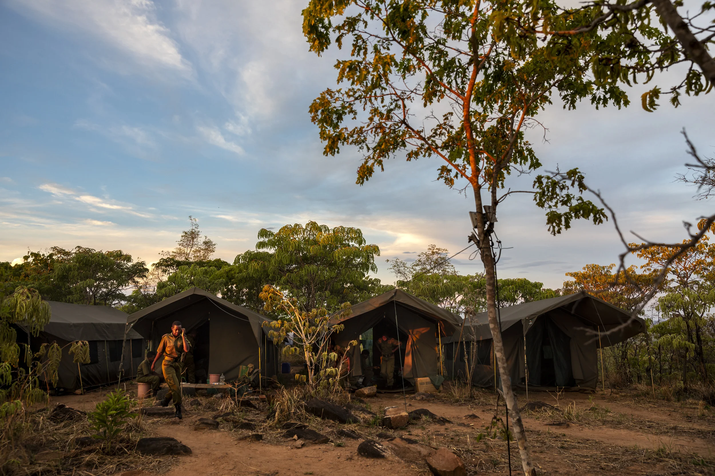PHUNDUNDU WILDLIFE AREA, ZIMBABWE, December 2018: Members of the all female conservation ranger force Akashinga seen in their spartan tent accommodation in their camp. Akashinga (meaning the ‘Brave Ones’ in local dialect) is a community-driven conservation model, empowering disadvantaged women to restore and manage a network of wilderness areas as an alternative to trophy hunting. Many current western-conceived solutions to conserve wilderness areas struggle to gain traction across the African continent. Predominately male forces are hampered by ongoing corruption, nepotism, drunkenness, aggressiveness towards local communities and a sense of entitlement.