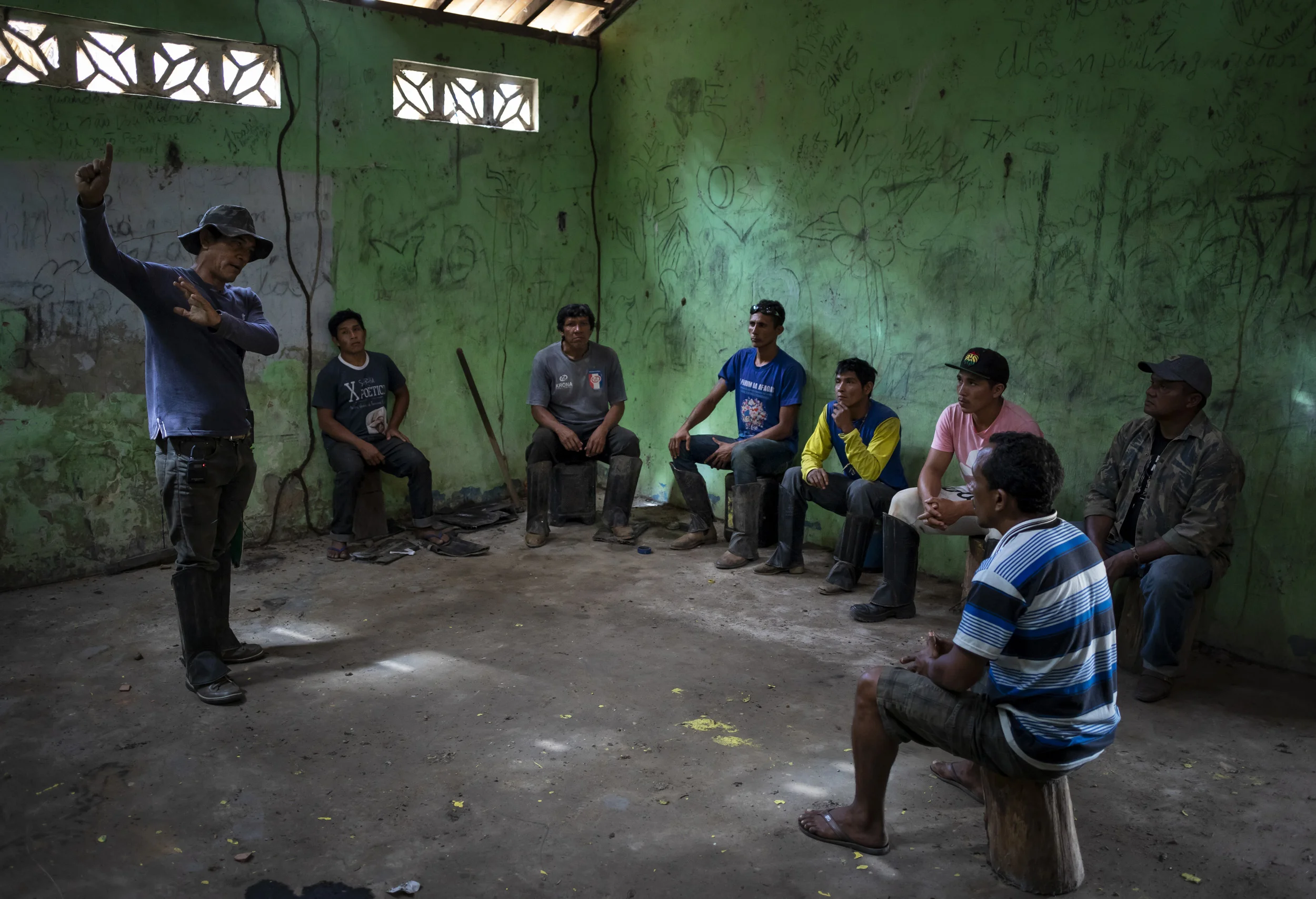 MARANHAO, BRAZIL, JUNE 2018: Members of the Forest Patrol attend a meeting before setting out on patrol in the village of La Goa Comprida in Arariboia Indigenous territory. In this village illegal loggers attacked locals when the locals confiscated their logging vehicles. One indigenous man, Tomes, was killed defending his wife and a logger was also shot. Tomes is survived by 2 daughters Graca Guajajara and Jaciane Guajajara. They remain in a deeply saddened state about his killing to this day. This village has little real funding but they continue to send out forest patrols they call forest guardians. This consists of motorbike patrols when they have fuel. Arariboia is the ancestral territory of the Guajajara, it encompasses 413,000 hectares of Amazon forest. The Guajajara share this land with the Awá Guajá, who live in voluntary isolation. Arariboia is the most populated territory we visited, with visible signs of deforestation in the areas we visited. The Guajajara have been organised since 2013 to monitor their territory, they call these patrols Indigenous Environmental Inspectors (Agentes Indígenas Ambientais). Arariboia is divided in 8 regions and each region has 15 inspectors, they all answer to one General Coordinator. In turn, the General Coordinator answers to a council of village chiefs. The inspectors received some funding for several years from FUNAI for transport and food expenses, in addition to some basic training. However, the funding stopped in 2015. Guajajara inspectors have engaged in violence against the loggers they apprehend, including beatings and setting on fire their equipment. These acts of violence seem to have taken place under the supervision of Olimpo Guajajara, who was reportedly removed from his position for these incidents. The Guajajara foresee no community enforced sanctions when their own are complicit in environmental crimes. The Guajajara will often acknowledge widespread participation of their own people in environmental cr