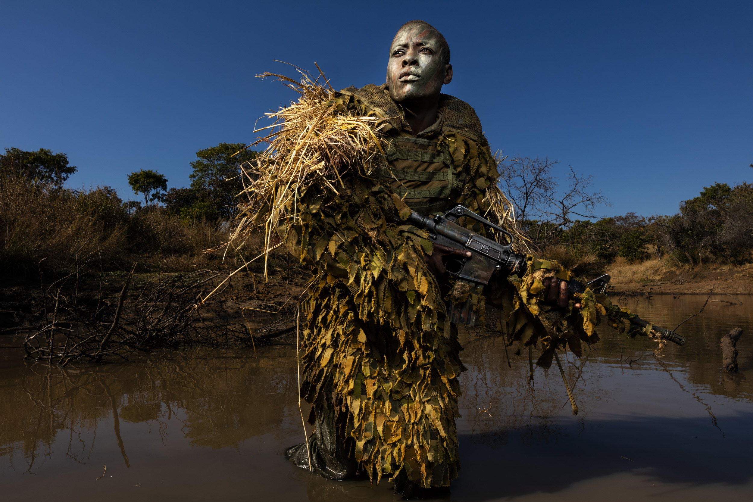 PHUNDUNDU WILDLIFE AREA, ZIMBABWE, JUNE 2018: Specially selected women from an all female. conservation ranger force undergo concealment and fire and movement training in the bush to curb poaching. Akashinga (meaning the ‘Brave Ones’ in local diale