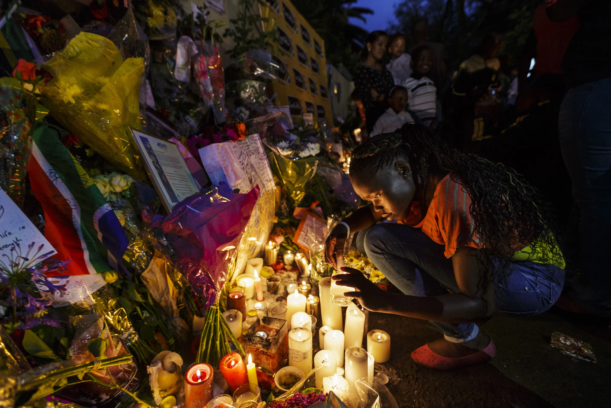 HOUGHTON, JOHANNESBURG, SOUTH AFRICA, 8 DECEMBER 2013: Mourners light candles and leave flowers outside of Nelson Mandela's Johannesburg home as crowds of people come to pay tribute to the icon of South Africa democracy, 8 December 2013. (Photo by Brent Stirton/Reportage by Getty Images.)