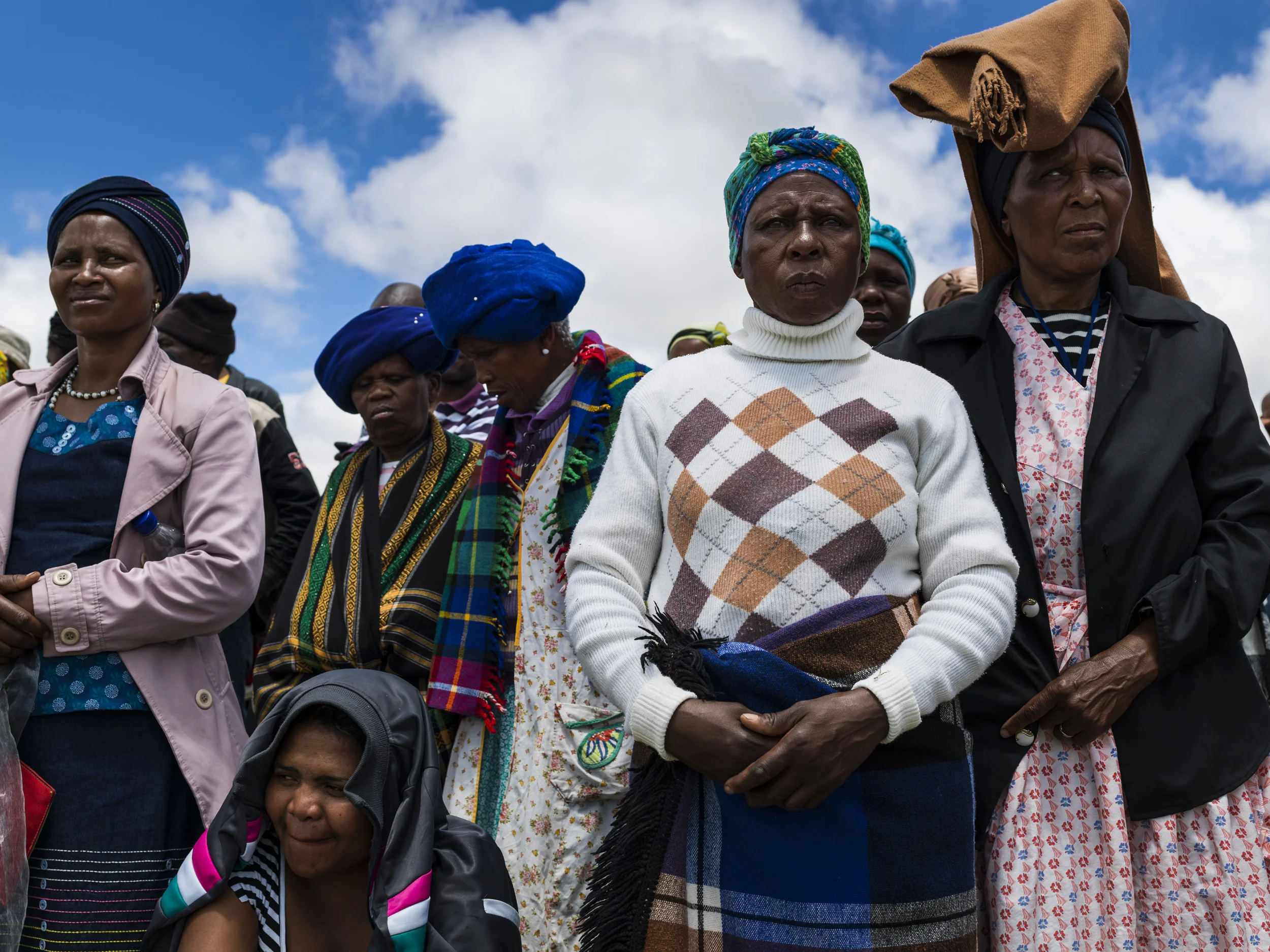 QUNU, EASTERN CAPE, SOUTH AFRICA, 14 DECEMBER 2013: Local Xhosa women watch the Mandela funeral service on a large television situated on a hilltop overlooking the service in the valley below, Qunu, South Africa, 14 December 2014. An icon of democracy, Mandela was buried at his family home in Qunu after passing away on the 5th December 2013. (Photo by Brent Stirton/Reportage by Getty Images.)