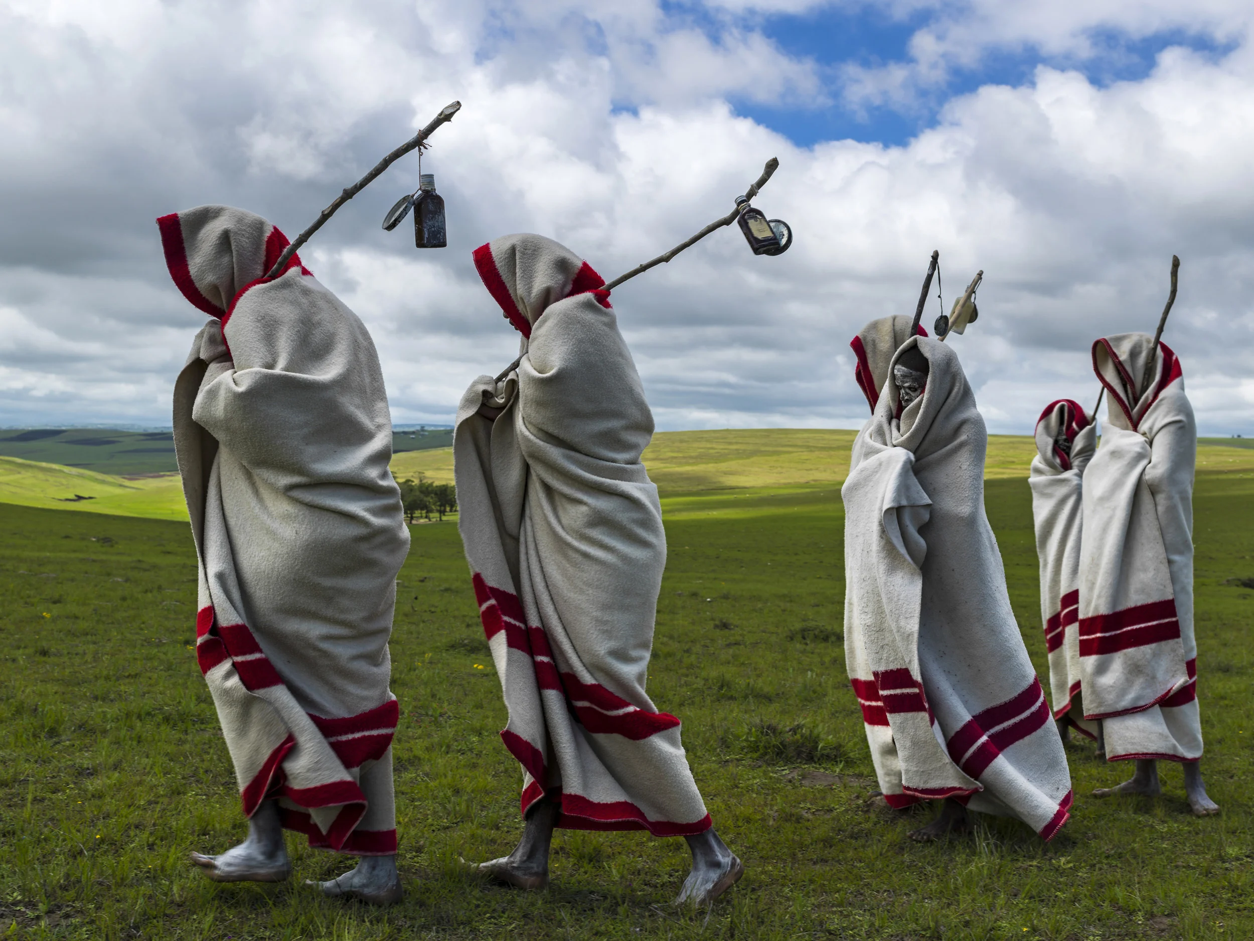 QUNU, EASTERN CAPE, SOUTH AFRICA, 14 DECEMBER 2013: Xhosa Initiates pass by close to the funeral of Nelson Mandela, Qunu, South Africa, 14 December 2014. These initiates have recently been circumsized traditionally and without anesthetic. They will spend up to two months dressed this way and learning the tradtions of Xhosa culture. Nelson Mandela, an icon of democracy, also went through this tradtional ritual. Mandela was buried at his family home in Qunu after passing away on the 5th December 2013. (Photo by Brent Stirton/Reportage by Getty Images.)