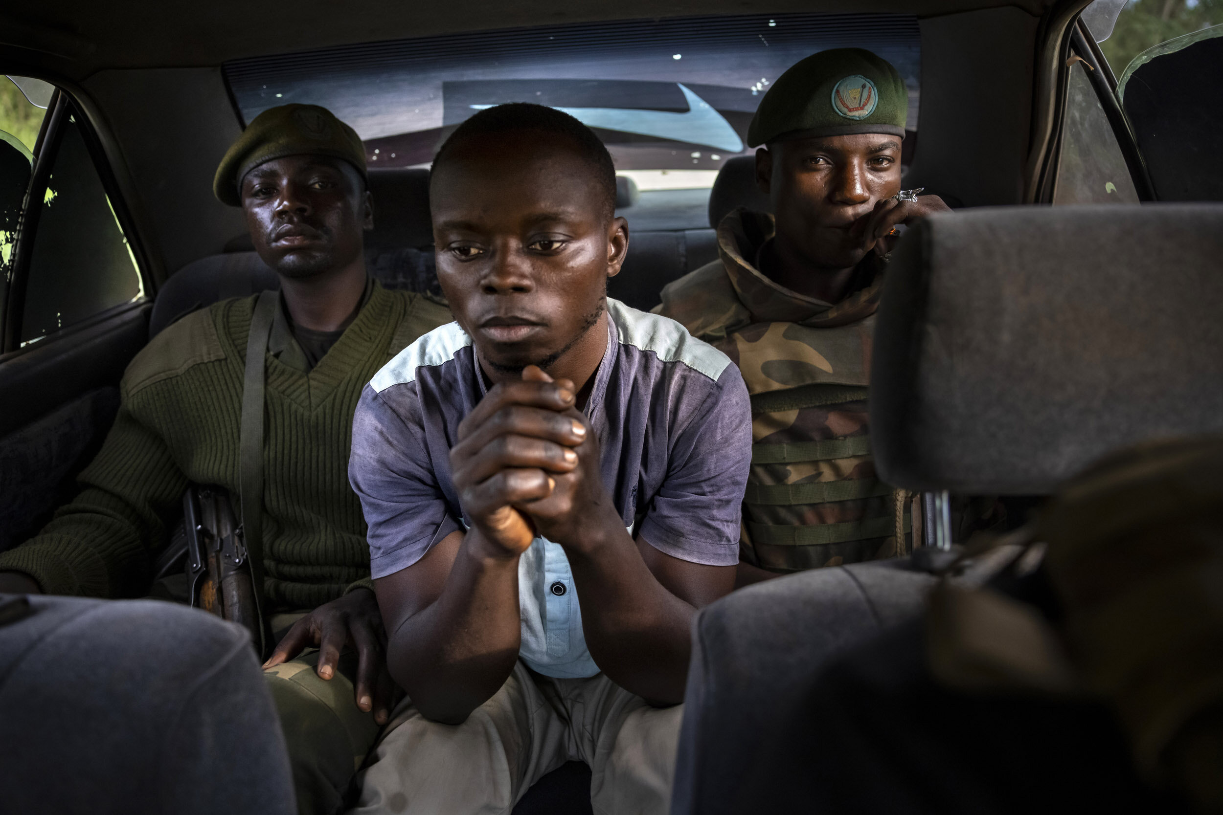 KASINDI, DEMOCRATIC REPUBLIC OF CONGO, 4 APRIL 2021: A Congolese man who is a suspected collaborator with Islamic terror group, the ADF, is seen under arrest in a vehicle on his way to interrogation by the Congolese army. He was named by two recentl