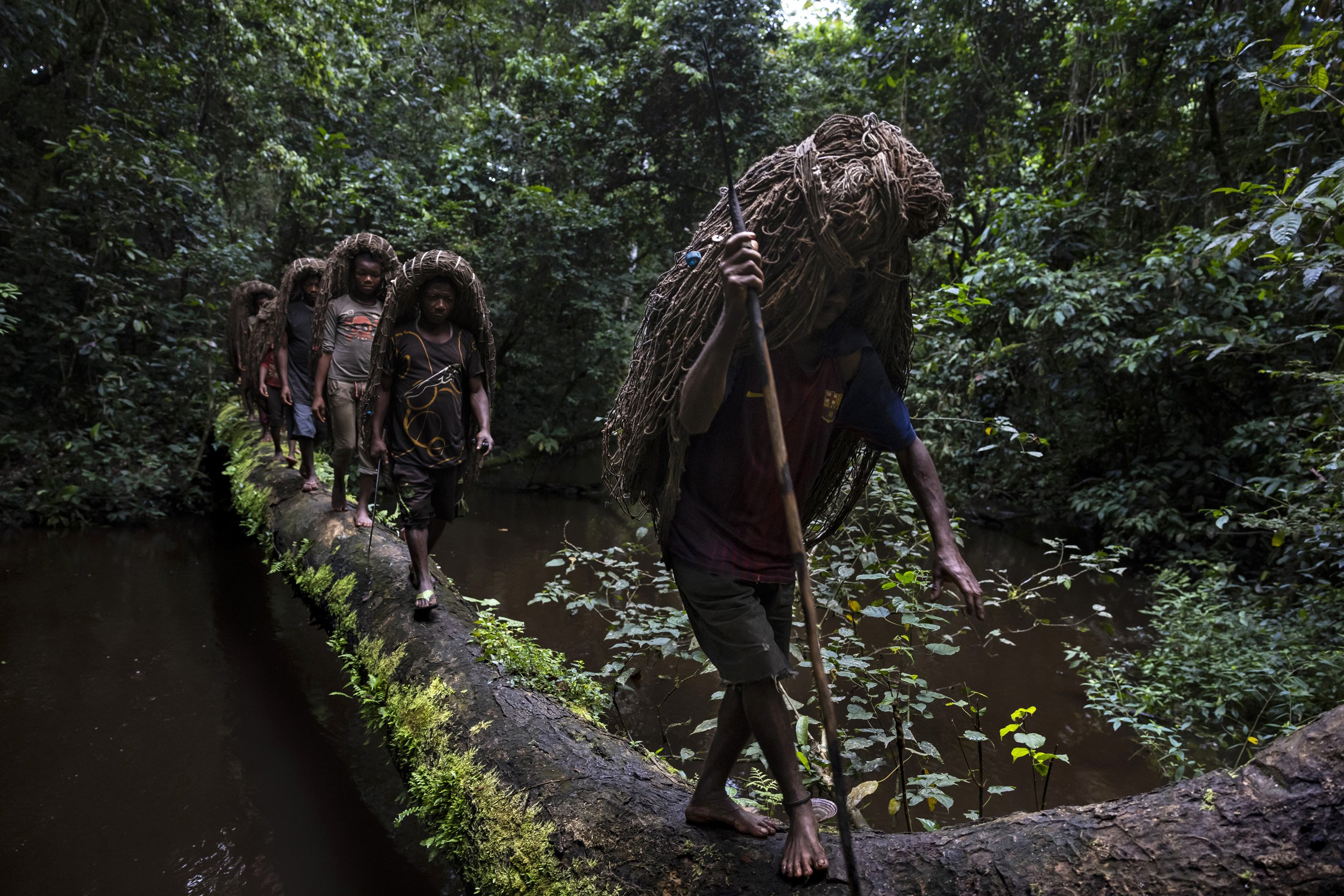 18. EPULU, ITURI, DEMOCRATIC REPUBLIC OF CONGO: An Mbuti Pygmy hunting group is seen on their way to hunt inside the forest in Okapi National Reserve. The Mbuti hunt wild meat in a sustainable manner, using nets they have created from forest vines.