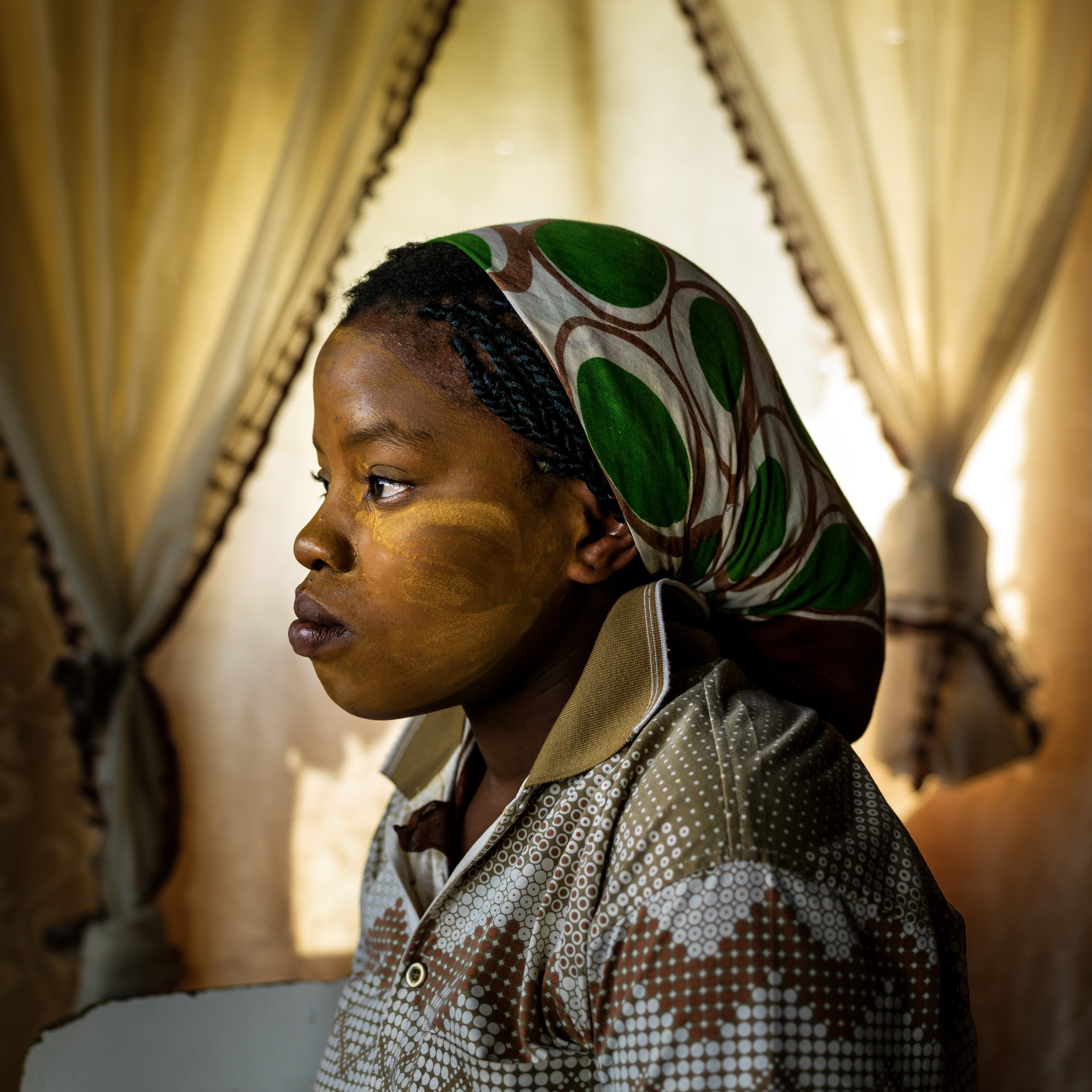 A young women sheds a tear as she watches Nelson Mandela's funeral in her small home in Qunu, the town where he was born and buried.