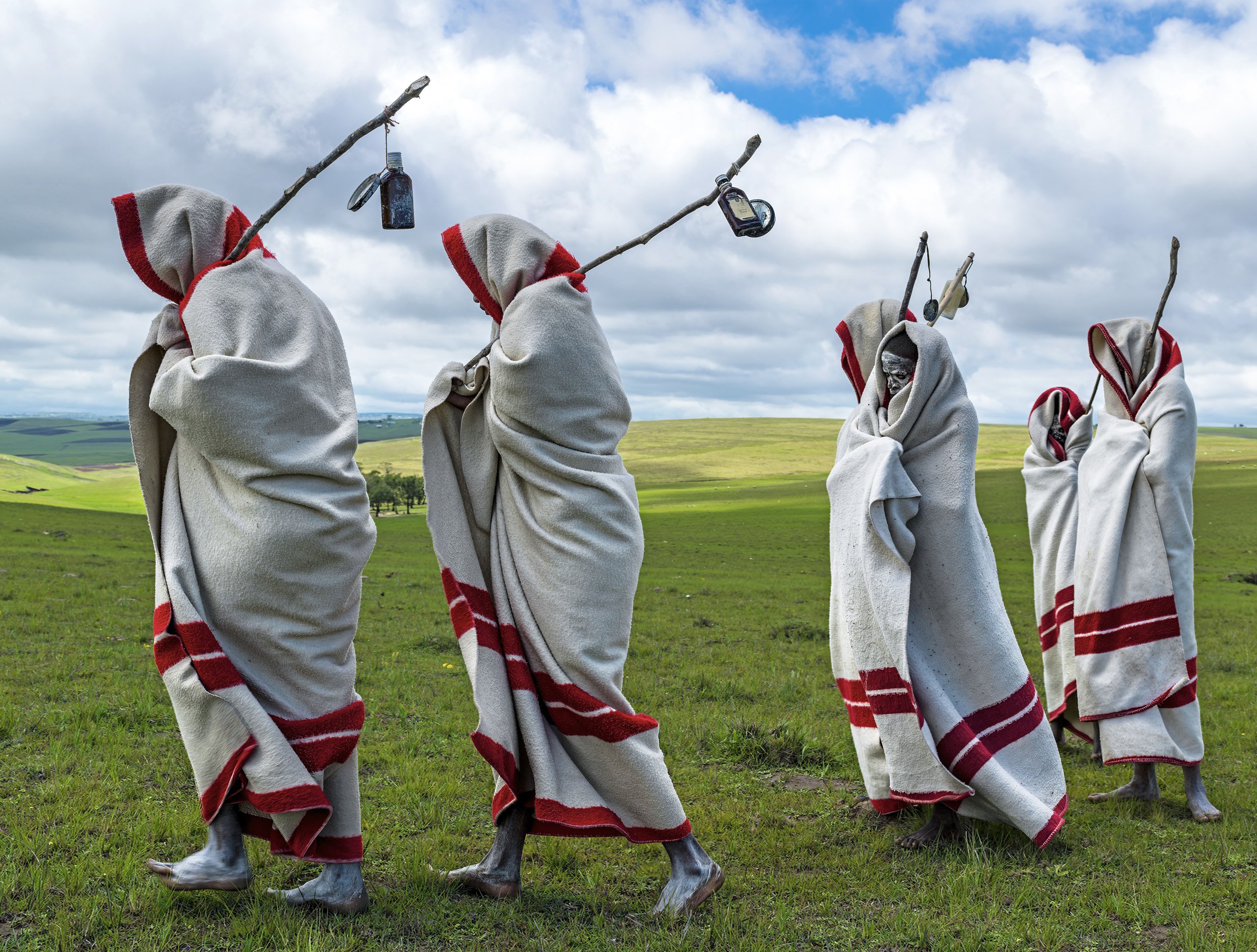 QUNU, EASTERN CAPE, SOUTH AFRICA, 14 DECEMBER 2013: Xhosa Initiates pass by close to the funeral of Nelson Mandela, Qunu, South Africa, 14 December 2014. These initiates have recently been circumsized traditionally and without anesthetic. They will