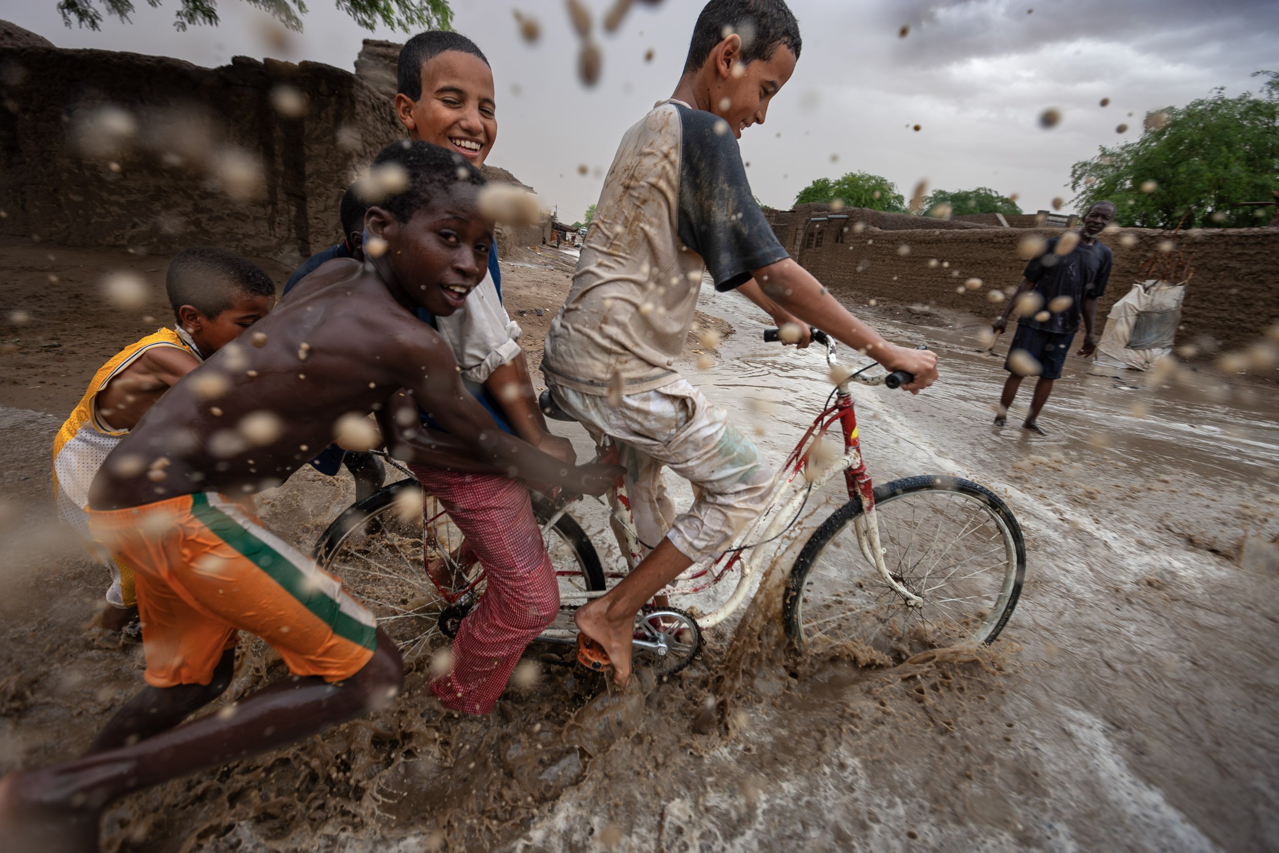 TIMBUKTU, SEPTEMBER 2009: Children play in the rain in a welcome respite from the desert heat in a street scene in Timbuktu, a historical Malian city, a long established centre of learning for Africa, , September 11, 2009. (Photo by Brent Stirton/Na