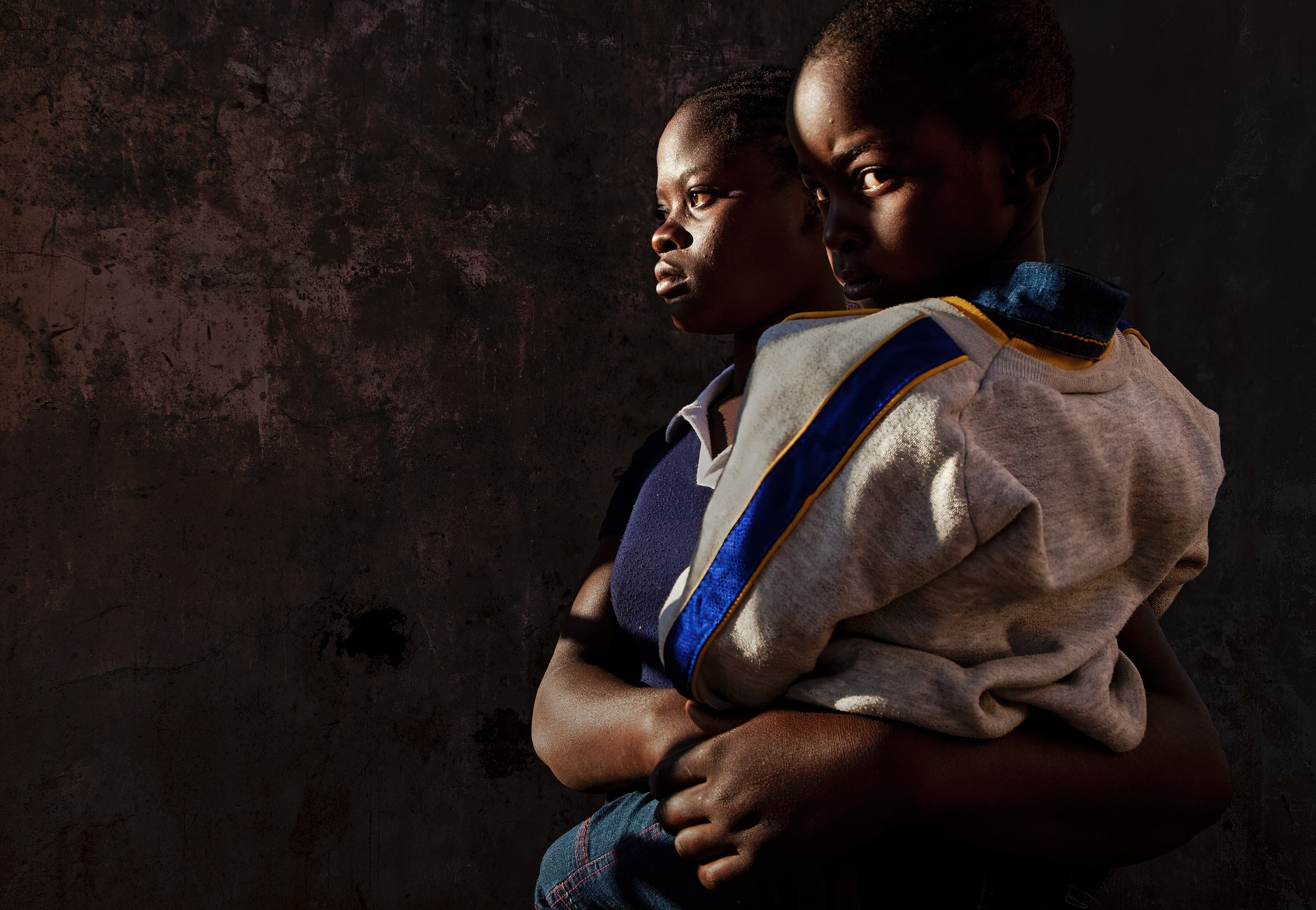 ZAKA, ZIMBABWE, JUNE 2009: A young widow holds her child in a house destroyed by Zanu PF in a rural area of Zaka, Zimbabwe, 24 June 2009. She lost her husband at the conclusion of 2008's March elections in Zimbabwe where the MDC emerged the winner.