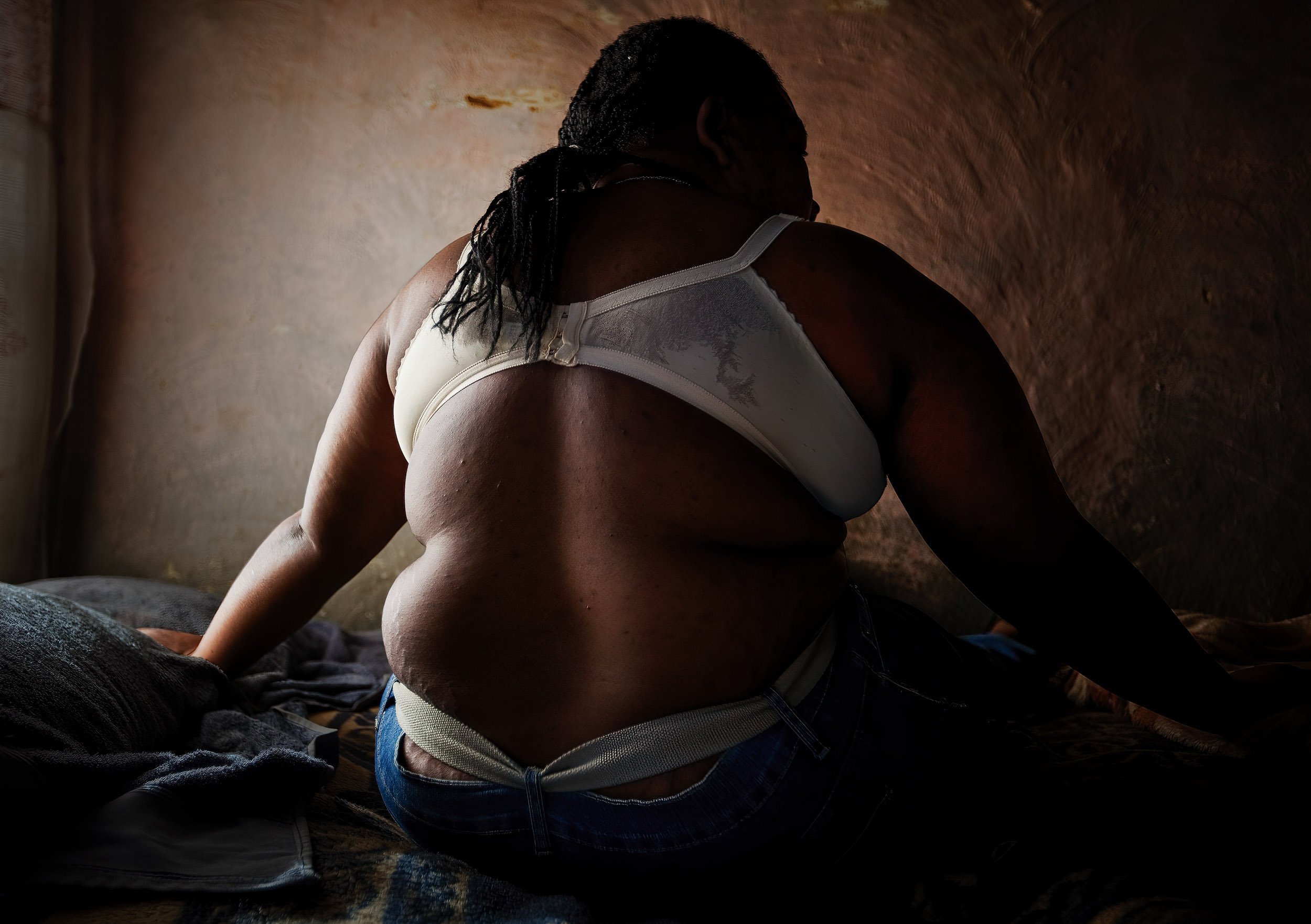 JOHANNESBURG, SOUTH AFRICA, JUNE 2009: Susan Matsunga, 30, is a former MDC Zimbabwean opposition party Secretary for Gender on a National level, she is photographed in her half of a one bedroom shack in Lenasia, Johannesburg, South Africa, 3 June