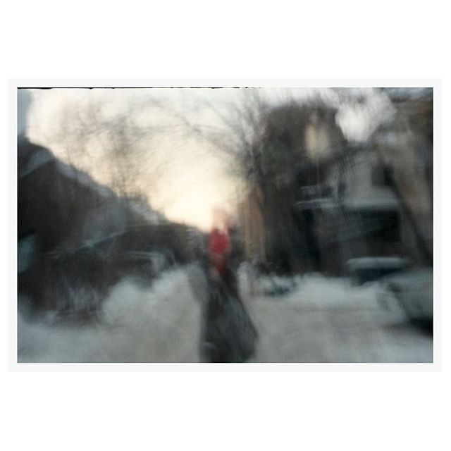 Karine in a snowy alleyway with red thread. Both 35mm, one pinhole. @letempsestunbateau