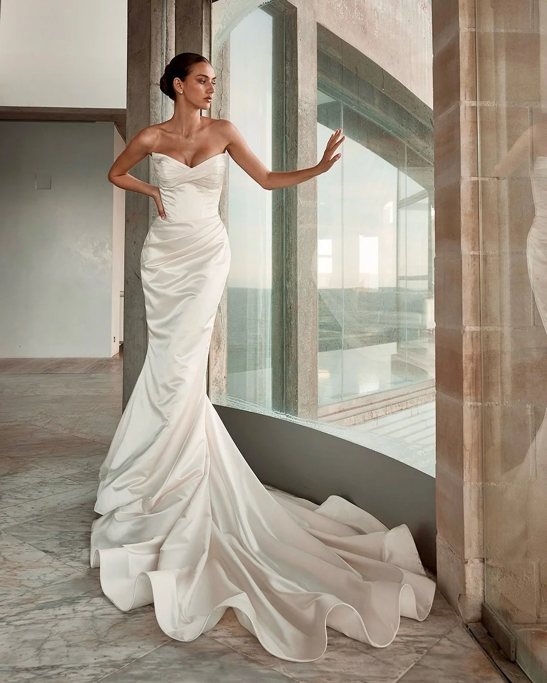 B E T H &mdash; sculptural, sleek, and quietly powerful 🤍

Crafted in luxe mikado with soft pleats that contour and define, paired with statement gauntlet sleeves and a sculptural veil for a bold, modern finish. Minimalism, redefined. ✨

💫 She&rsqu