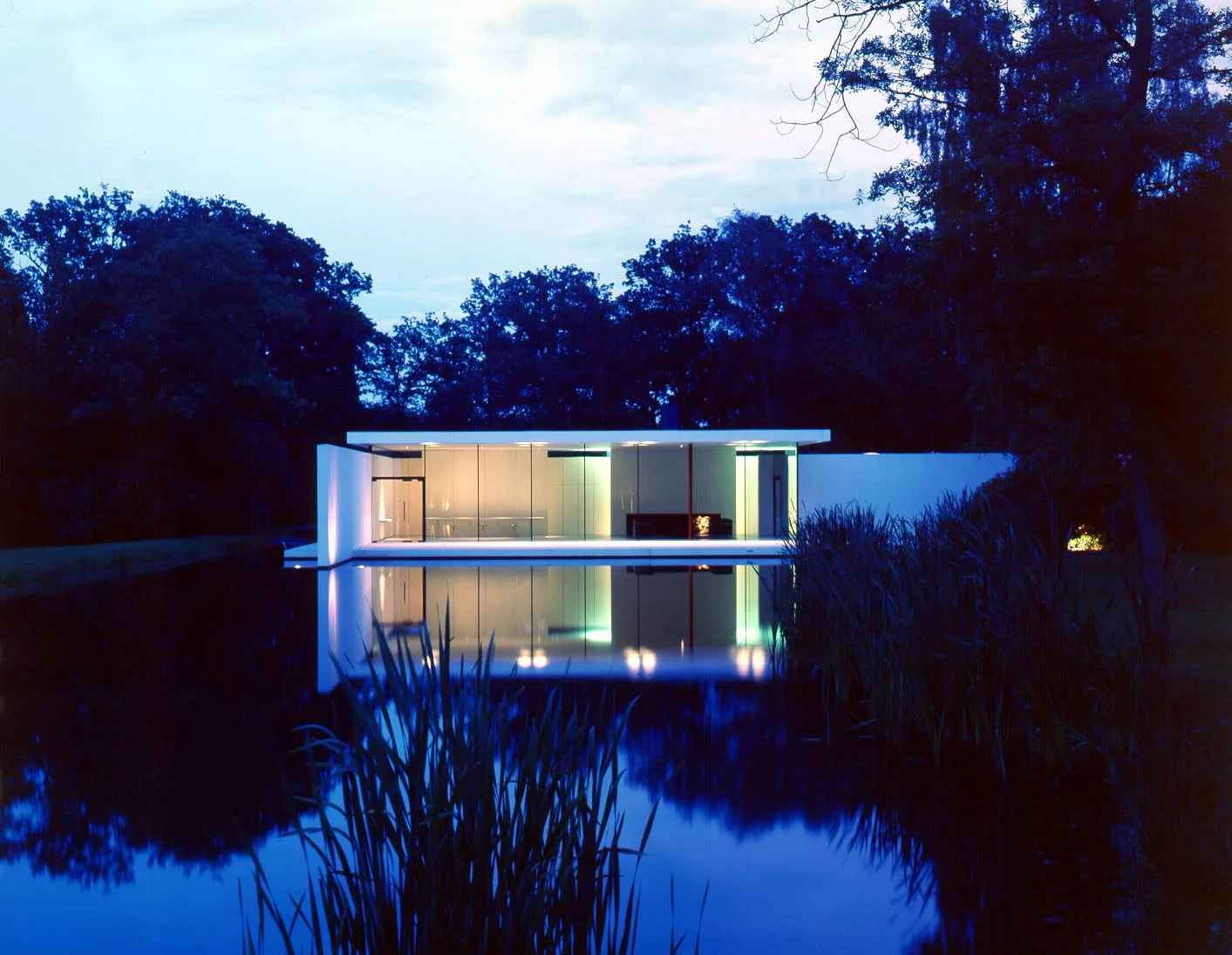Skywood Houise at dusk seen from across the lake .