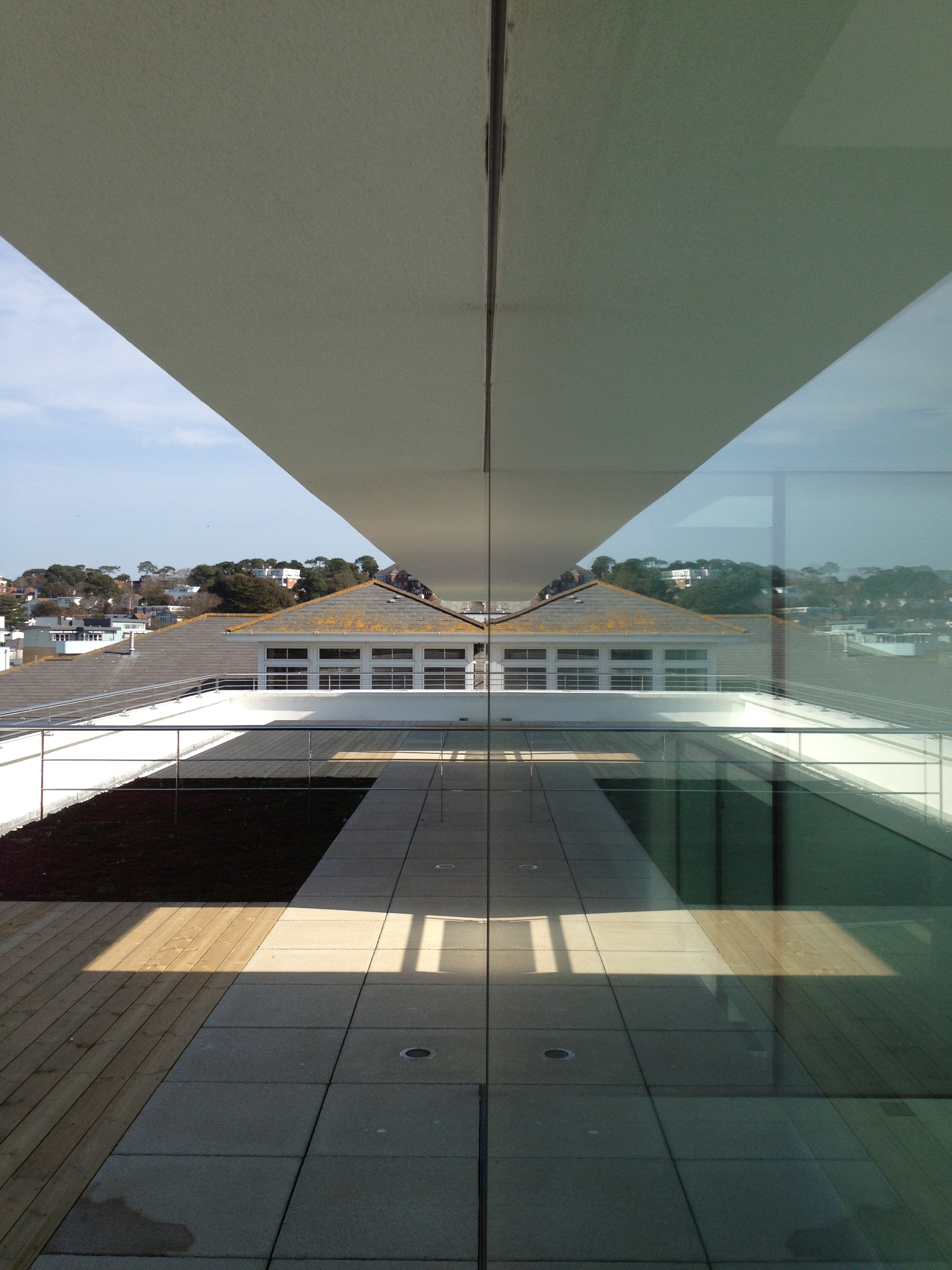 The flush detailing of the glass walls creates dramatic reflections .