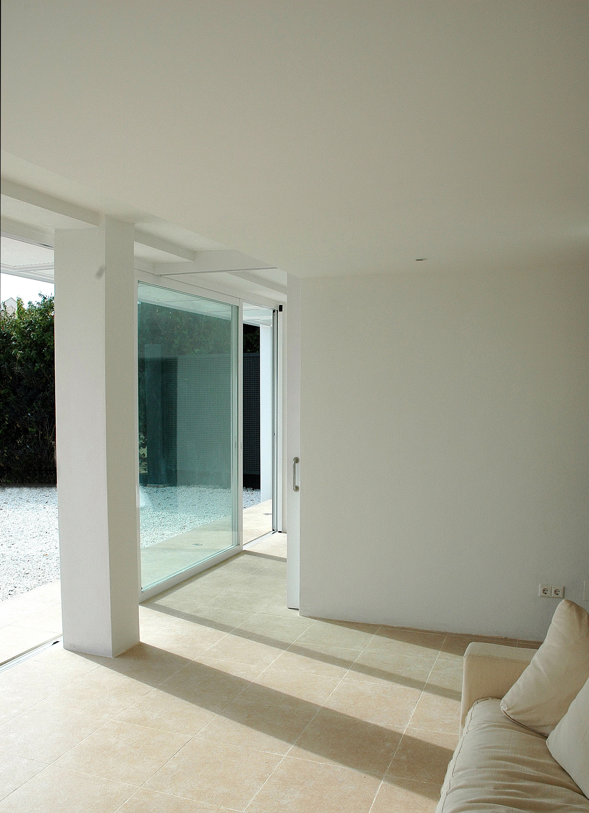 Part of the wall between the living area and master bedroom was replaced with a large full height sliding door panel the creates an even more open interior.