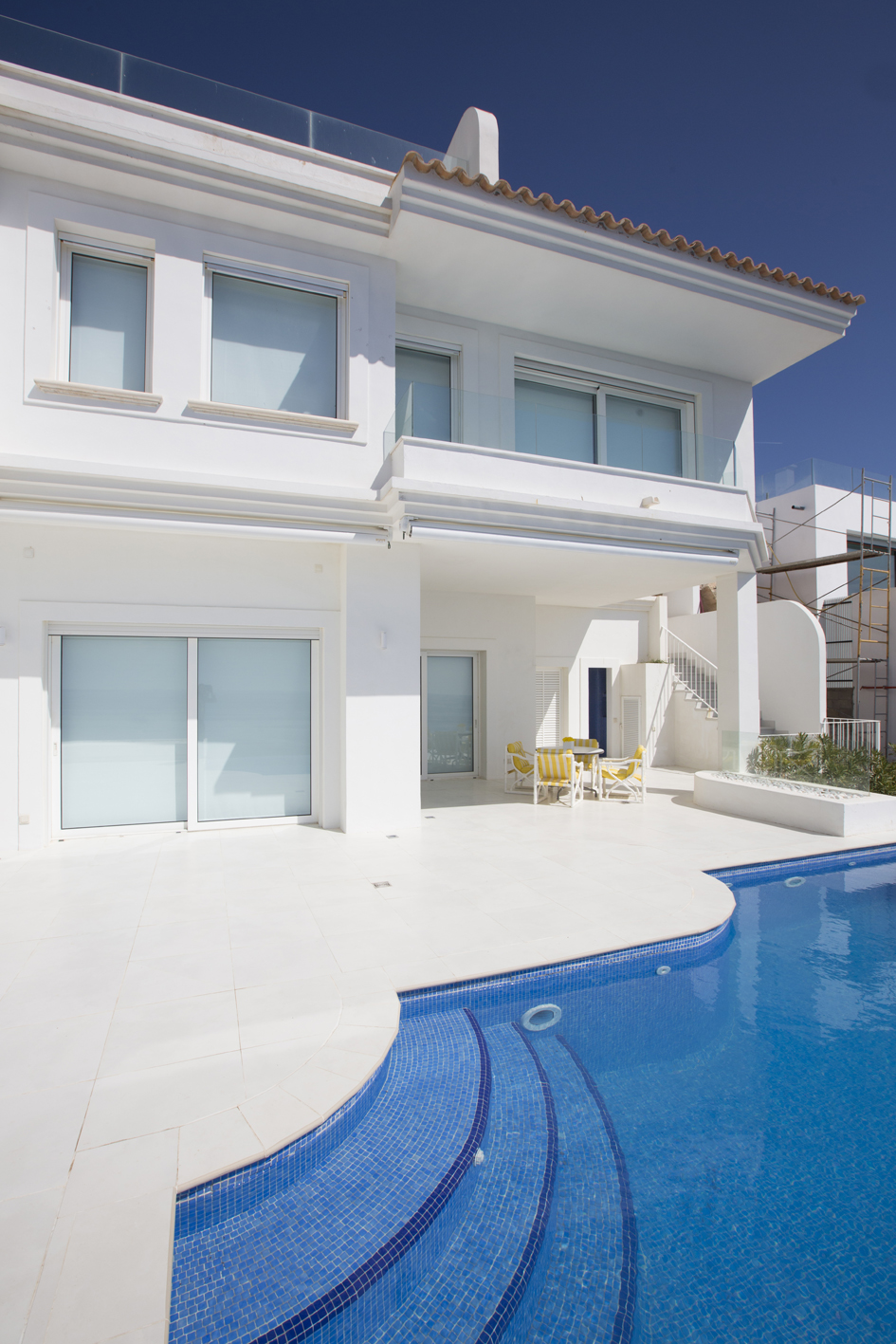 The fully renovated west facade had all its arched window openings remodeled to include external roller shutters . A new balcony was added to the master bedroom and the terracotta terrace repaved with white tiles. There are retractable awnings over