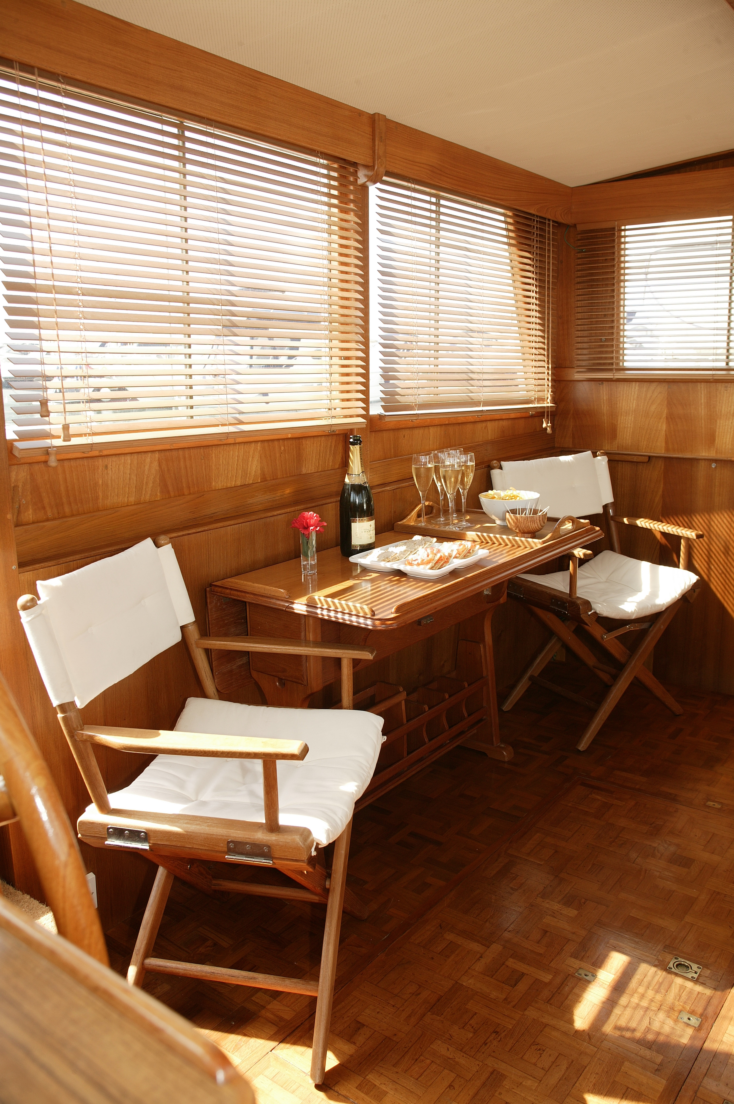 The interior was redesigned removing the original fixed seating to create a flexible interior and using matching veneer for the Burmese teak.Timber venetian blinds were added to the windows.