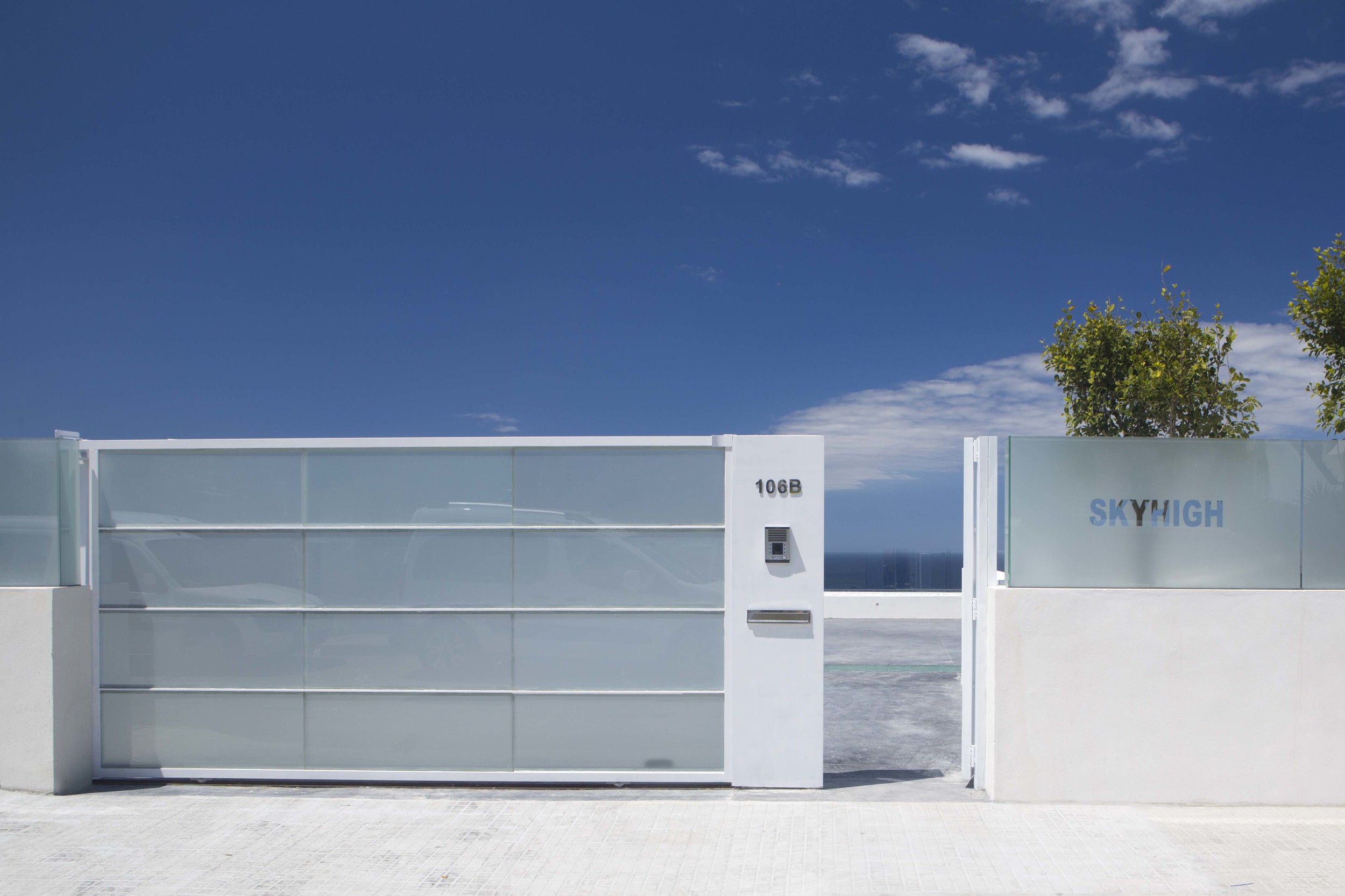 The entrance gates in translucent glass and SKYHIGH name in clear glass. 