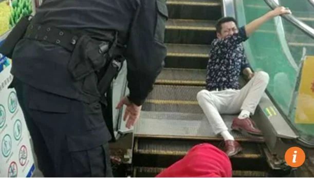Hmmm.....man gets buttocks stuck in escalator. Just another day in China. 