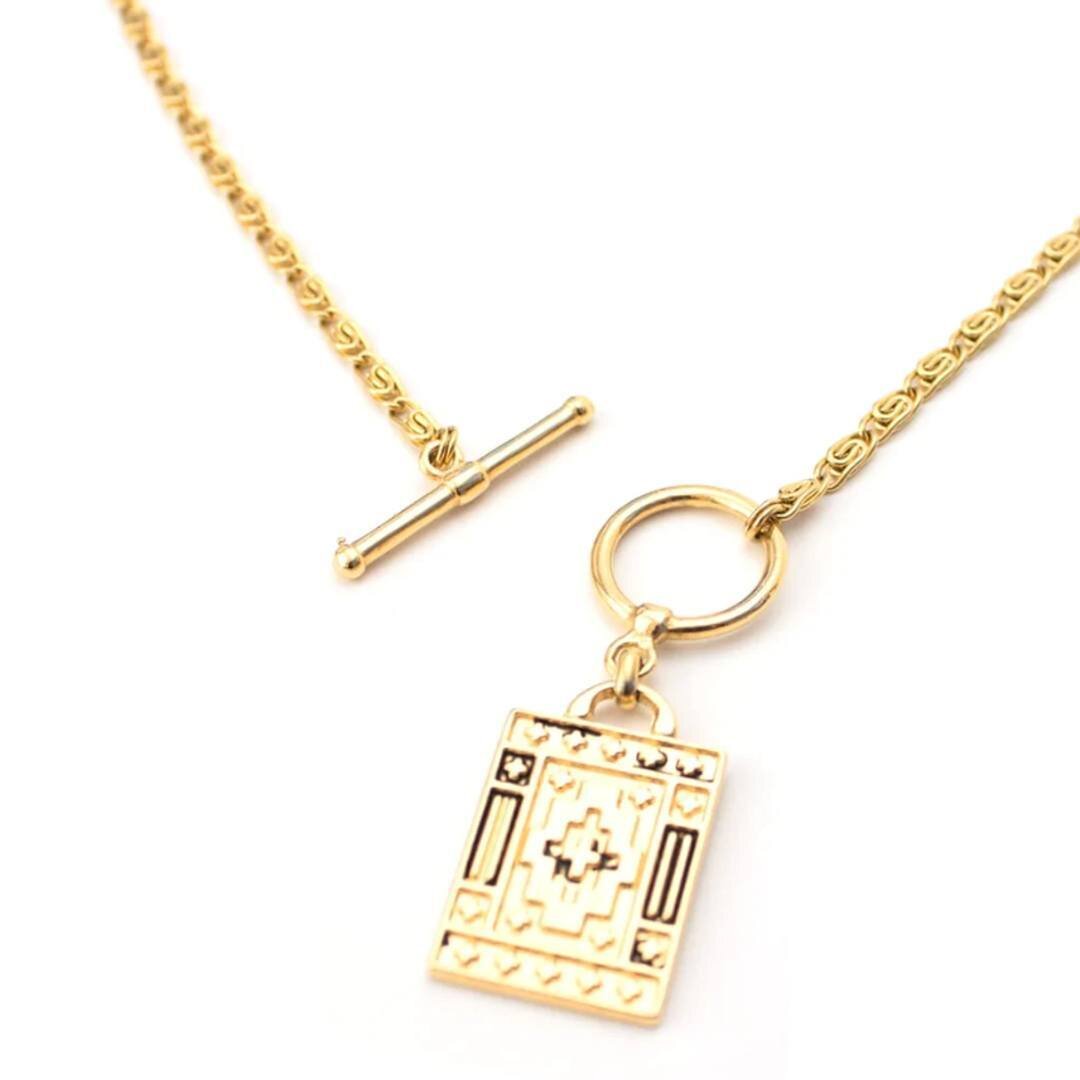 Layering made easy with a timeless piece. Damien is a short gold toggle clasp necklace featuring a gold plated stainless steel snail chain. Wrap it around your neck and the 24 karat gold plated rectangular engraved medallion will do all the talking!
