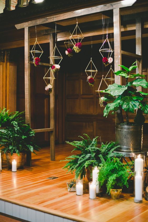 24-an-indoor-wooden-arch-with-hanging-geometric-decor-and-bold-flowers.jpg