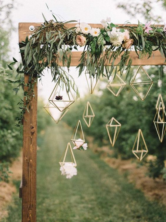 23-a-wooden-arch-covered-in-delicate-florals-hanging-geometric-figures.jpg