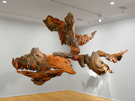Shades of brick red and brown swirl together in this hanging organic sculpture.