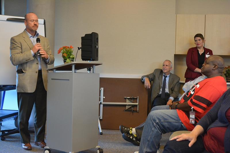 Kevin Jones , left, spoke briefly to accept a Housing Heroes award from San Mateo County on Oct. 22, while county health and recovery director Stephen Kaplan and Telecare housing coordinator Lee Cates (seated) and PSC II Yesenia Cortes (standing) listen. Cates was recognized as a Housing Hero in 2013.