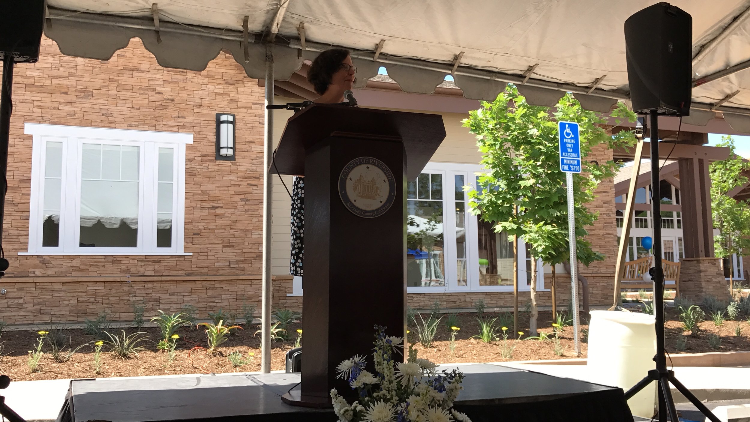  Faith Richie, SVP of Development, speaks at the Lagos ribbon cutting ceremony and open house on May 3. 