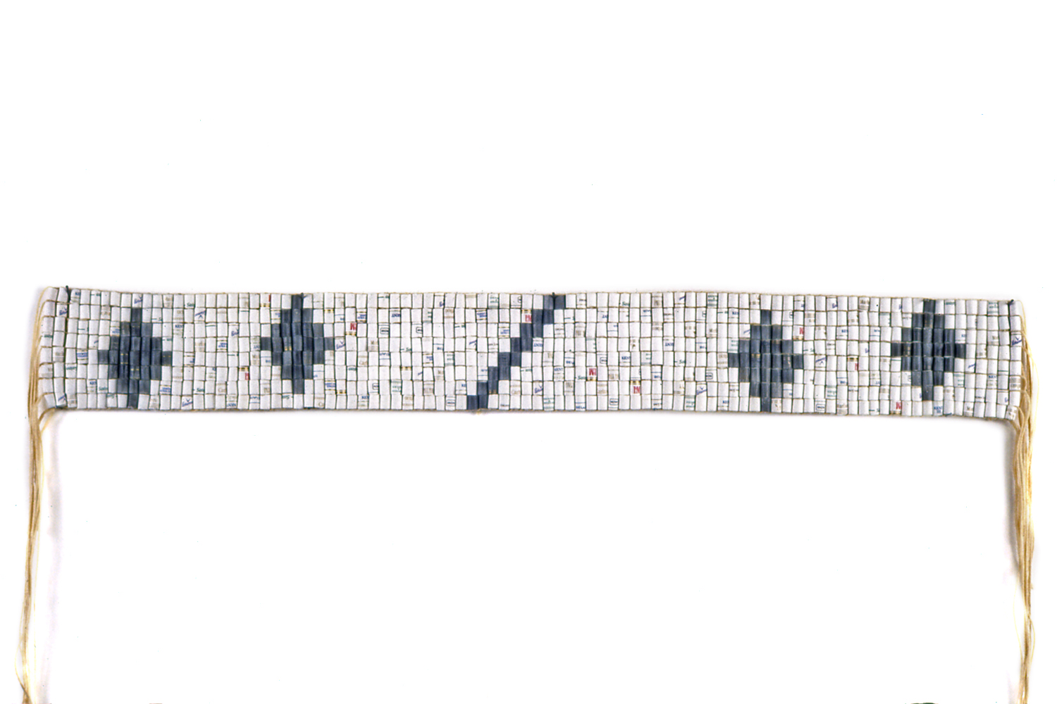 CONDOLENCE BELT With cigarette filters substituted for shell beads, this hand-woven belt is patterned after an Iroquois wampum belt that was used to express condolence. 