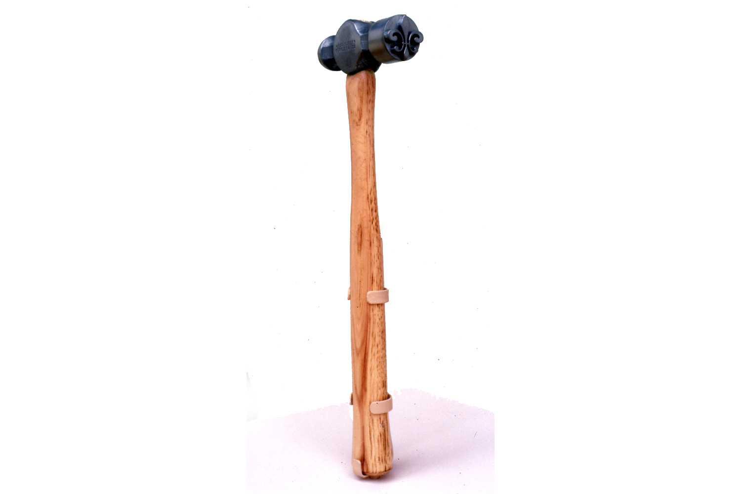 BRUISE HAMMER A cast hammer with raised fleur-de-lis motif for producing decorative bruises.