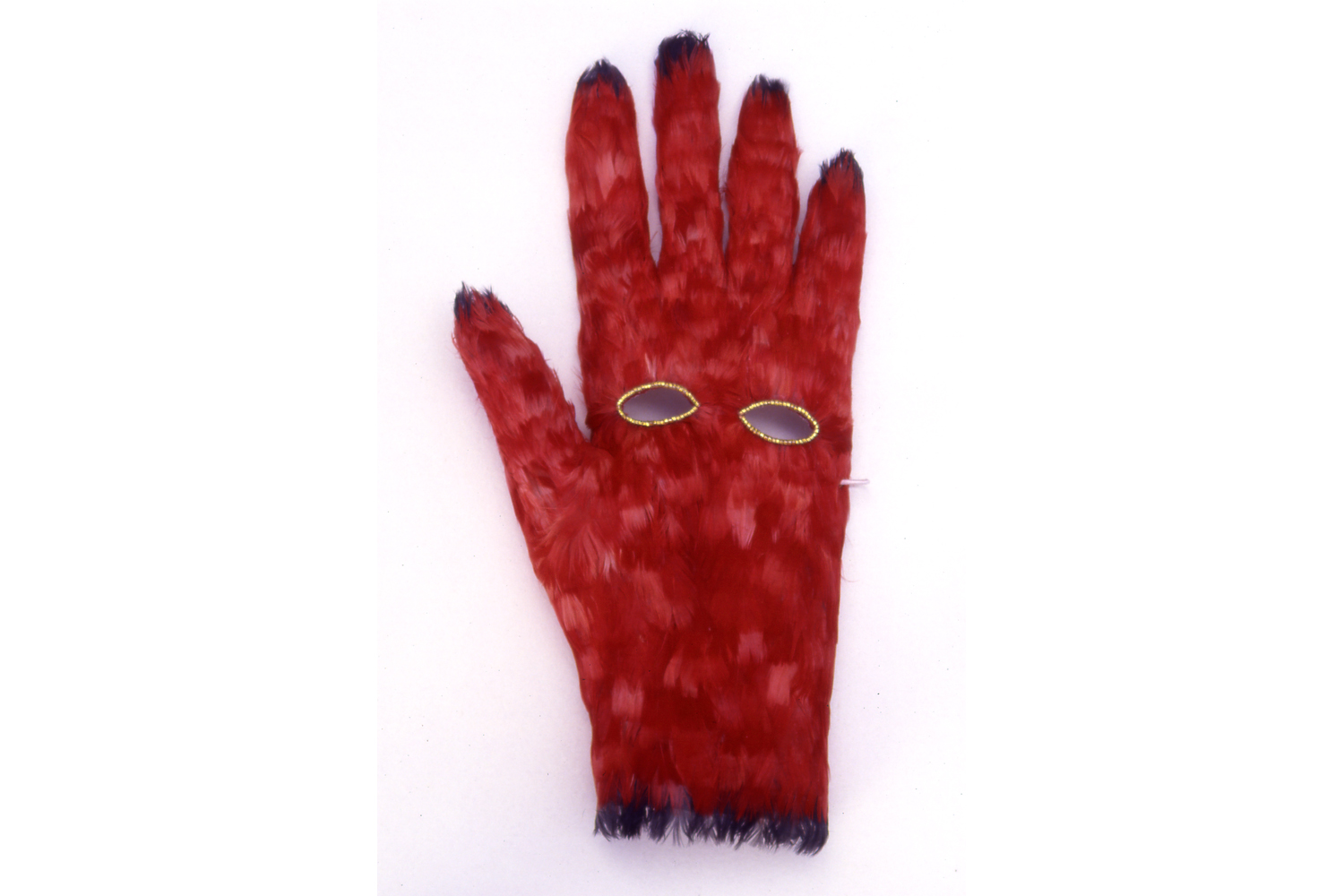 THE GLOVE IS THE MASK OF THE HAND A feathered glove with elastic strap that "masks" the palm of the hand. Part of an ongoing series HOW TO SEW A GLOVE, a collection of hand-made conceptual gloves, each accompanied by an original poem. 
