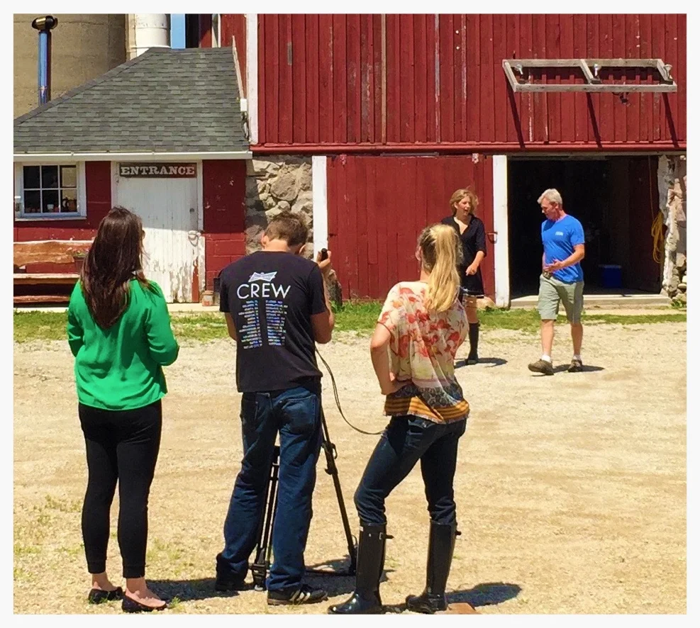 Director and crew filming Jen Duncan talking barn wood and design logistics.