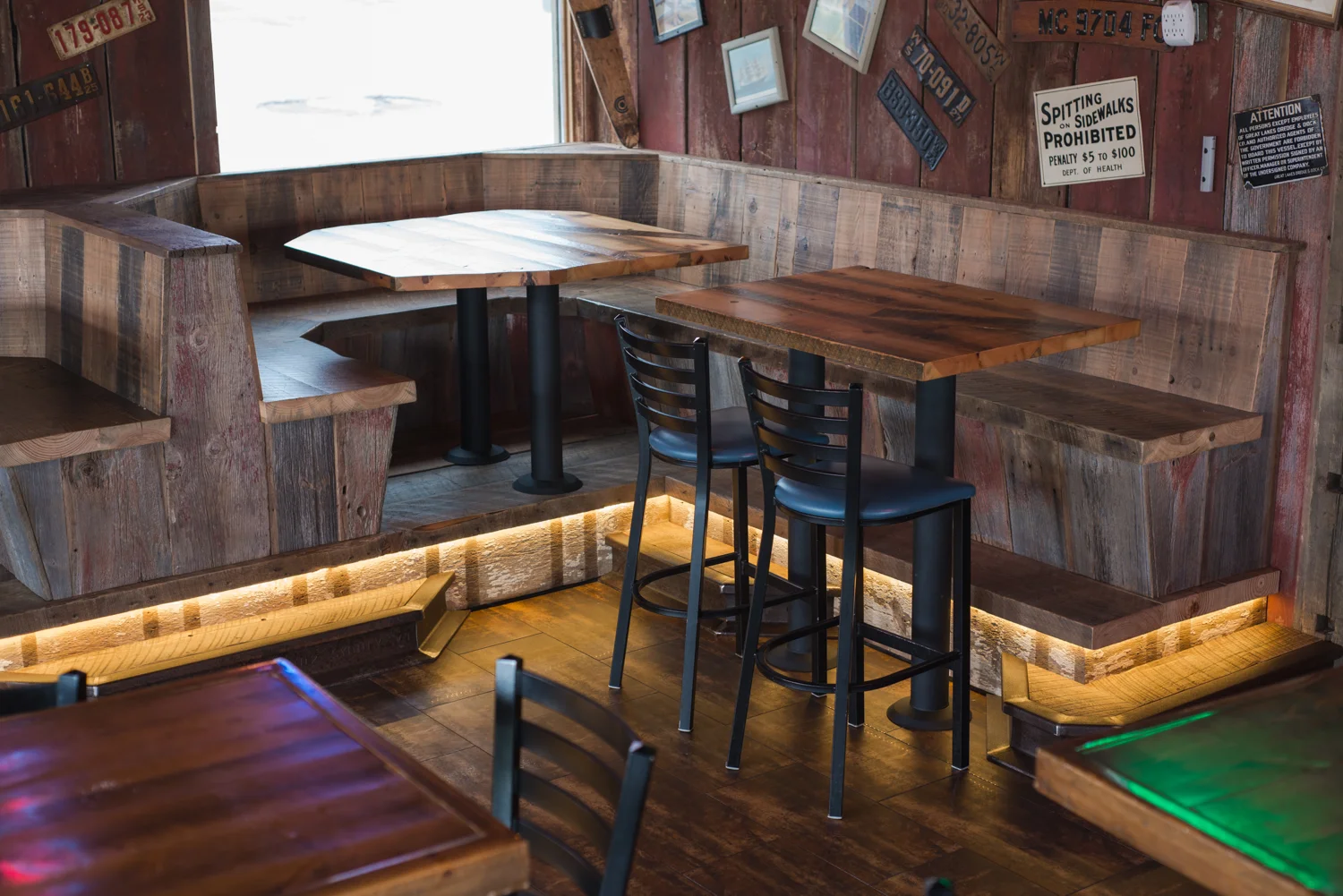 Rail step up to a corner booth creates height enough to match the pub tables.