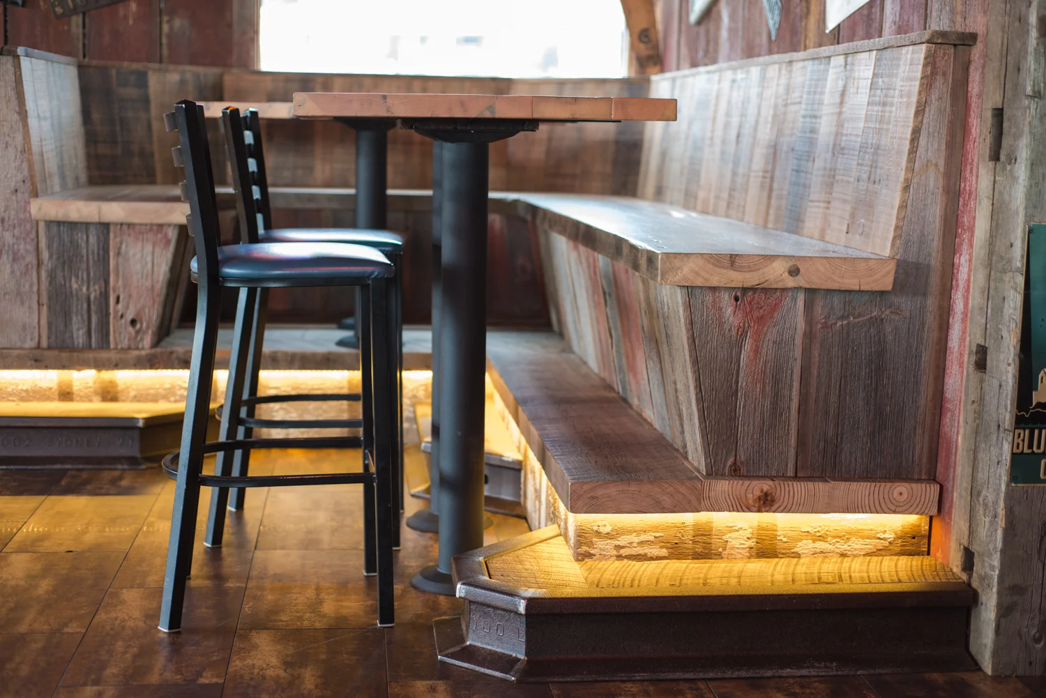 A variety of authentically weathered barn wood planks anchor the vintage design of Harpoon Willie's dining booths.