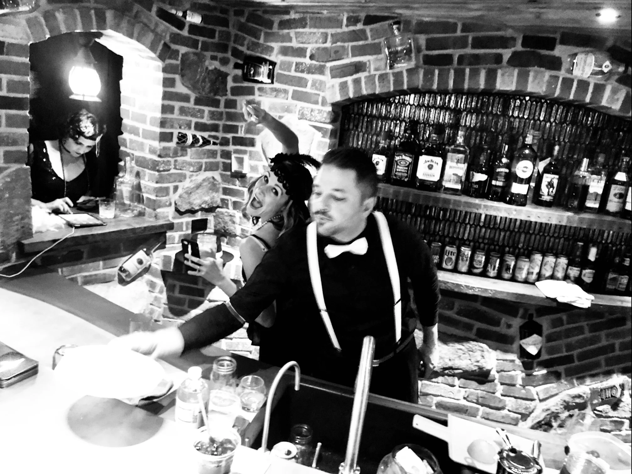 Shenanigans behind the bar. Notice the bottles embedded in the brick.