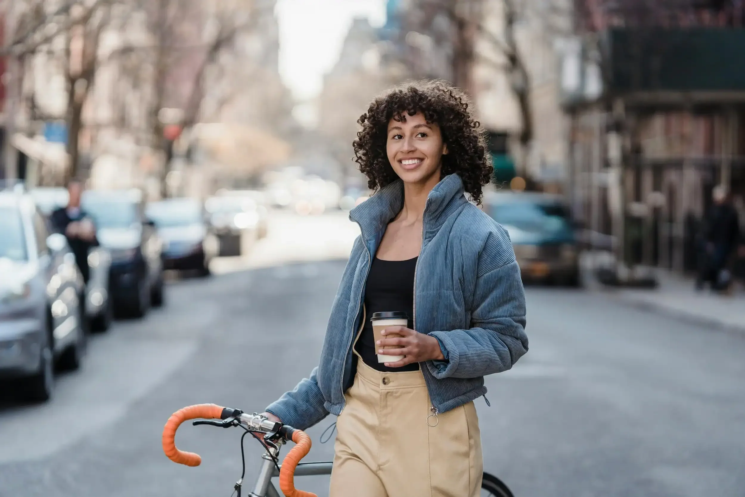 A happy female counselling client with her bike