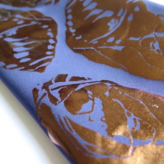 Cocoon illustrated in foil print on scuba material