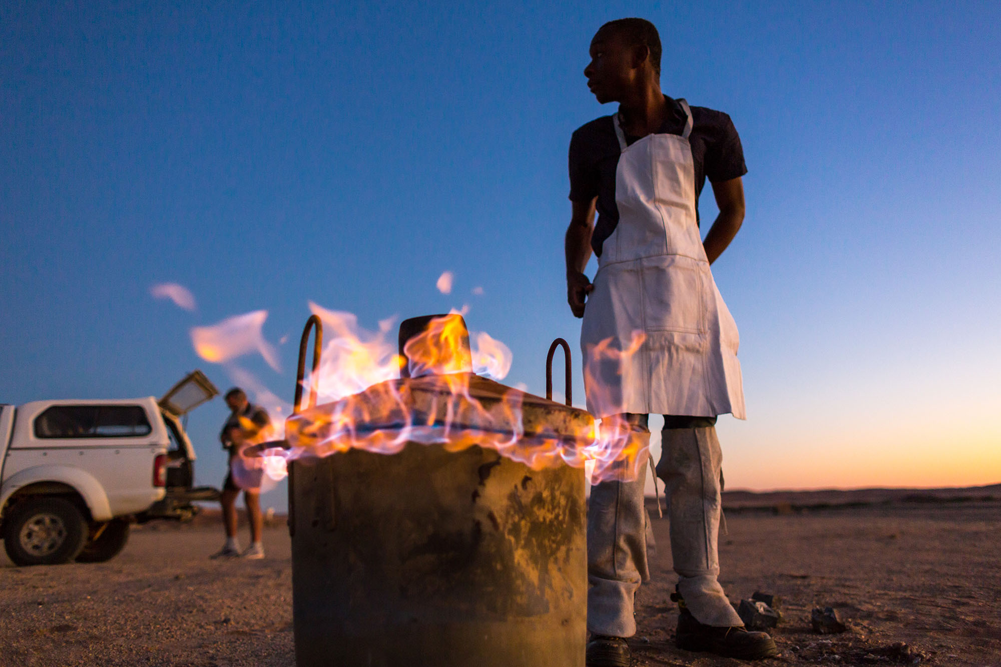 Above: Martin Handjaba prepares to create a negative burrow casting by heating zinc to its melting point of 419.5 °C.