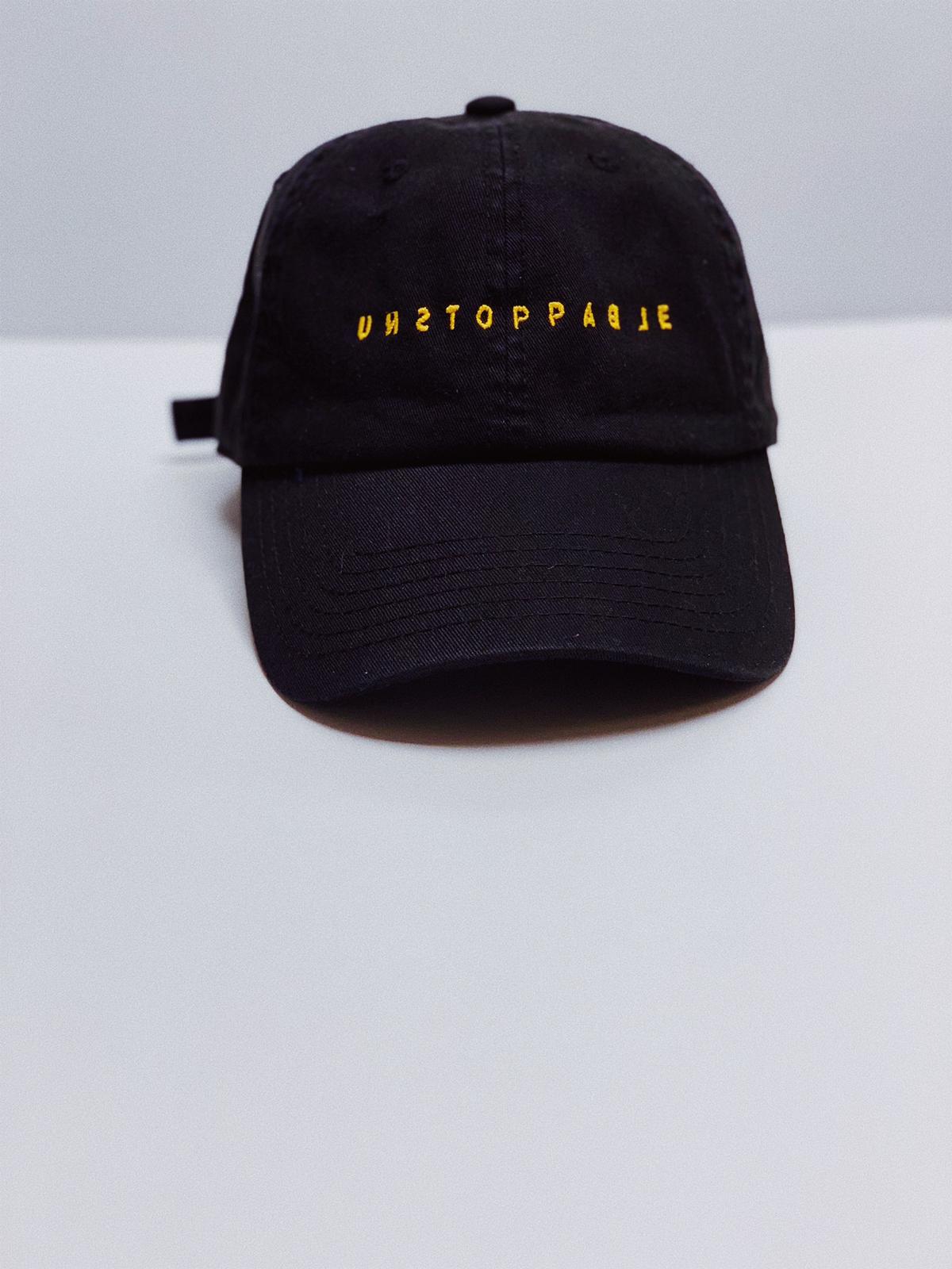 black and yellow dad hat.jpeg