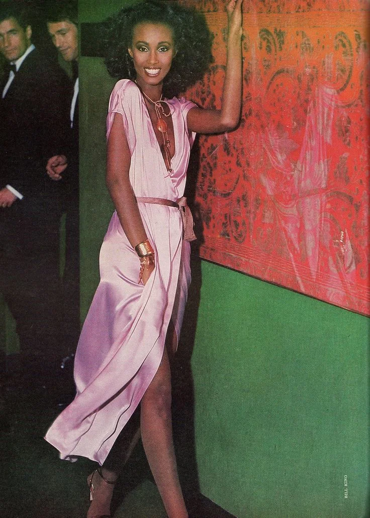 Photo of Supermodel Iman in 1978 wearing a solid pink DVF inspired wrap dress by Calvin Klein 