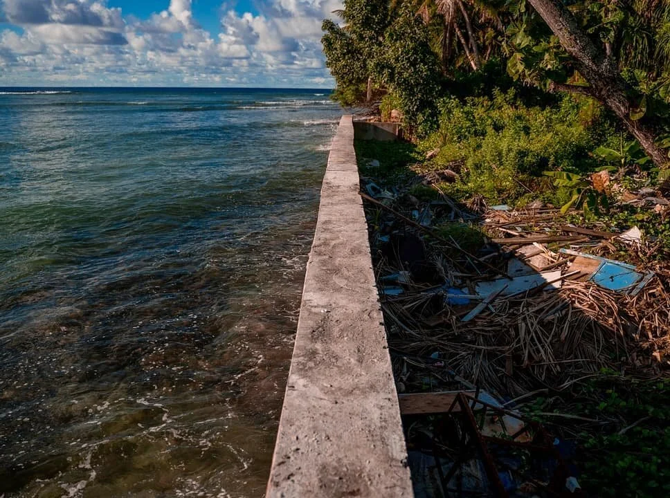 In some parts of the Marshall Islands, this is all that's keeping the ocean from someone's backyard. Unfortunately, it's also the only thing keeping trash from the ocean. 

While it is sad to see trash floating out in the ocean, it's also just the si