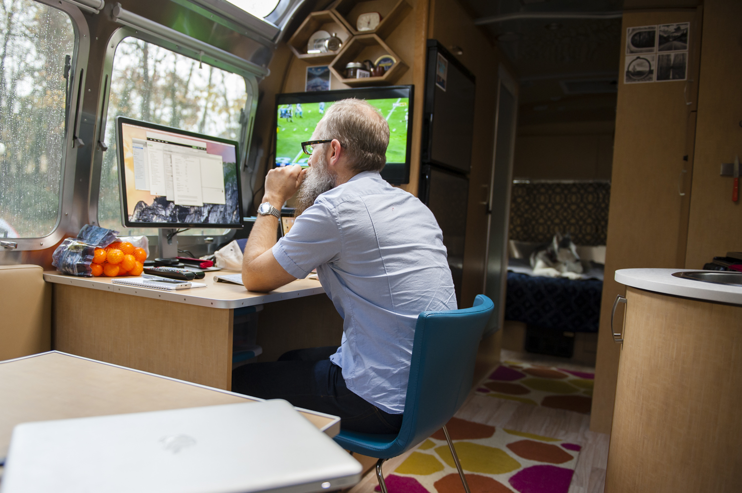 Sunday at Rivet and Roam headquarters. Bill edits photos and watches football while Inga lounges on 'her' bed.