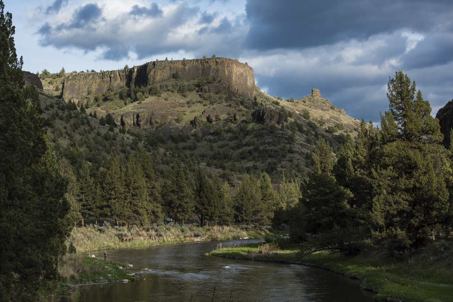 I spy Bill fishing with Chimney Rock in the distance.
