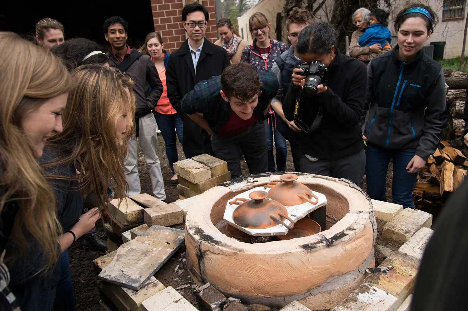 Unloading our replica ancient Greek kiln after our oxidation-reduction-reoxidation firing to see our finished examples.