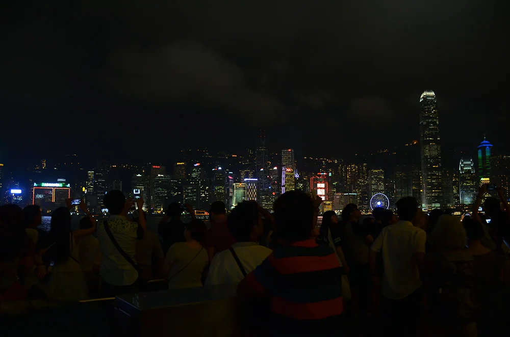 A lot of people making videos of the light show. This happens every evening at 8:00 PM at the harbor.