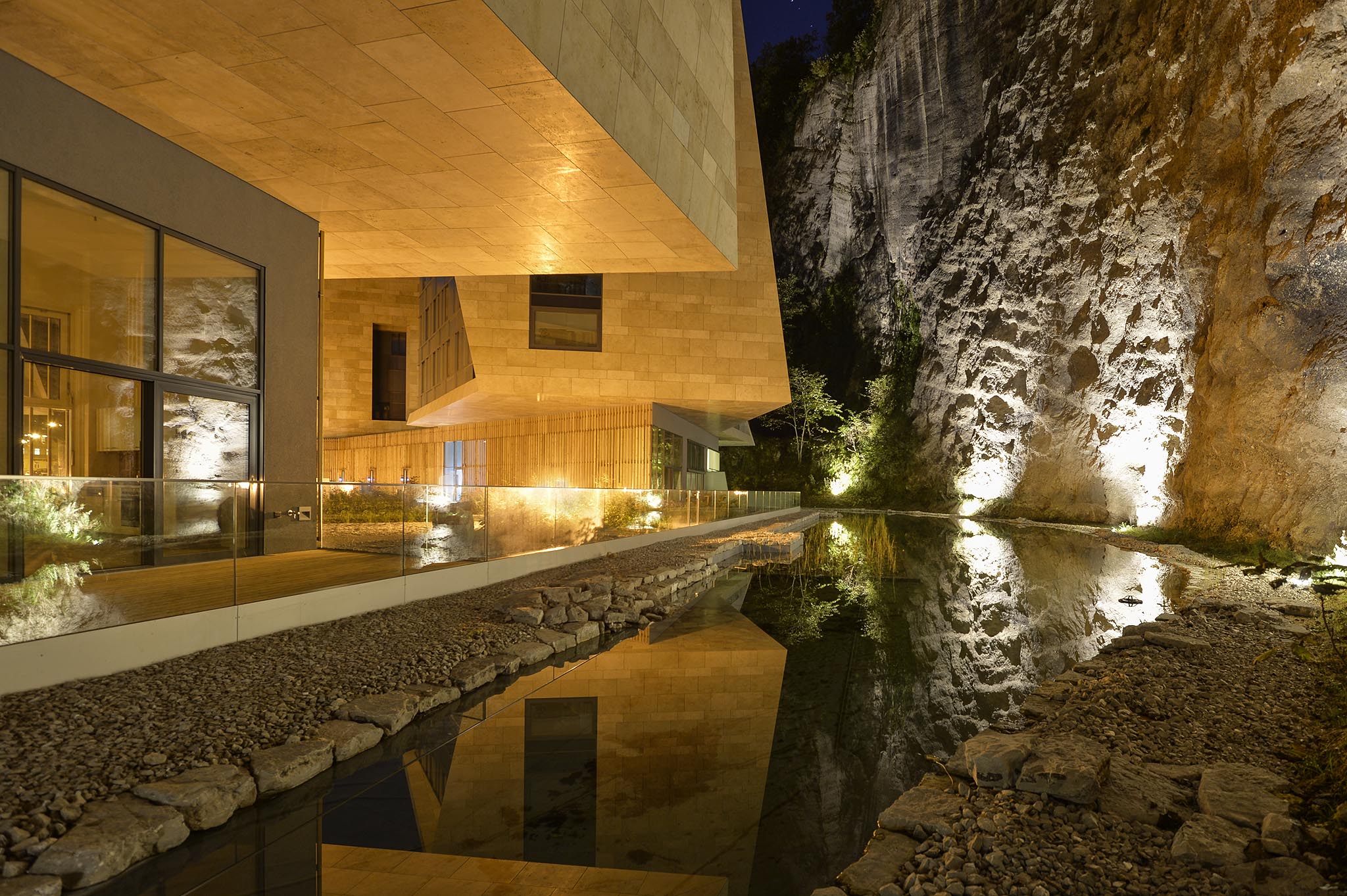 23 Night View of Building C ground floor terrace with water and rock face.jpg