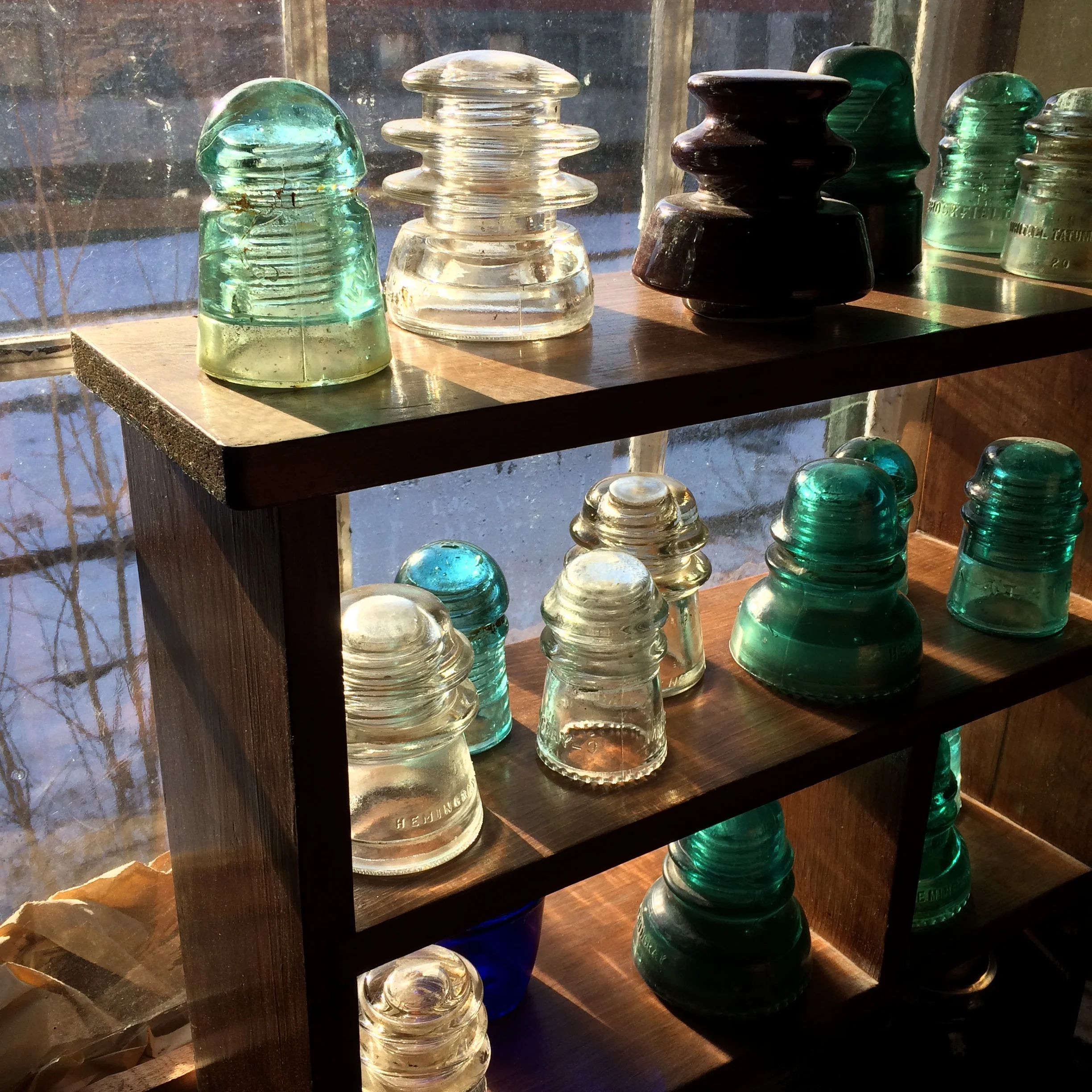 Glass insulators in the winter sun. Photo credit: Jimmy Grackle
