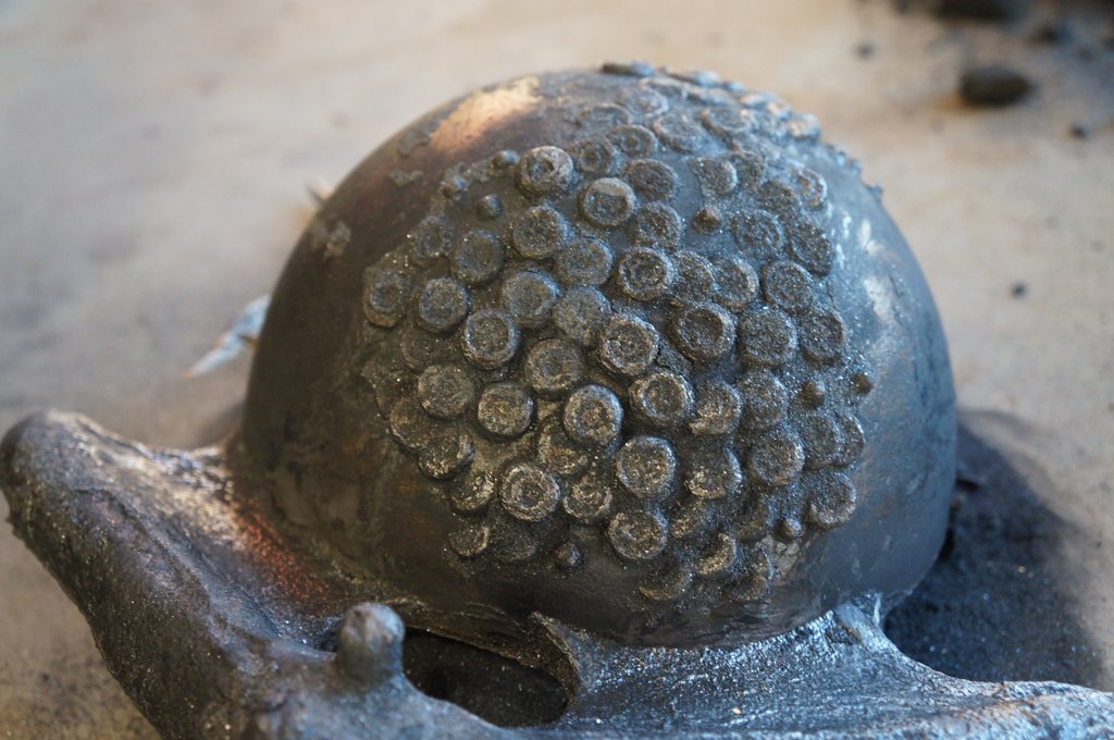 3. One mold has been removed to show the actual sculpture inside. Now all the gates and channels on the outside have to be removed, the whole things cleaned up (yes, there is bronze beneath that charred surface) and both halves put together, fi