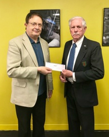 Dr. Graham Elliott, AYPO Executive Director, receiving the first installment of the grant from William Bannon, Foundation Trustee