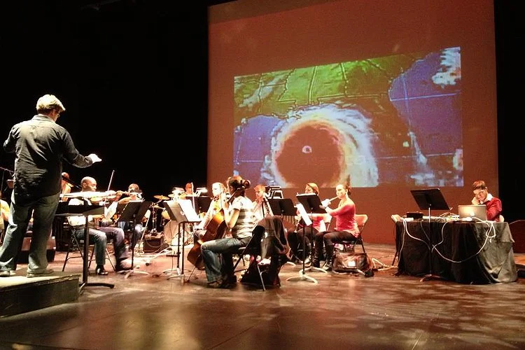 David Vickerman leads a performance of "Katrina Ballads" as part of an educational social justice initiative at The College of New Jersey in March 2015.